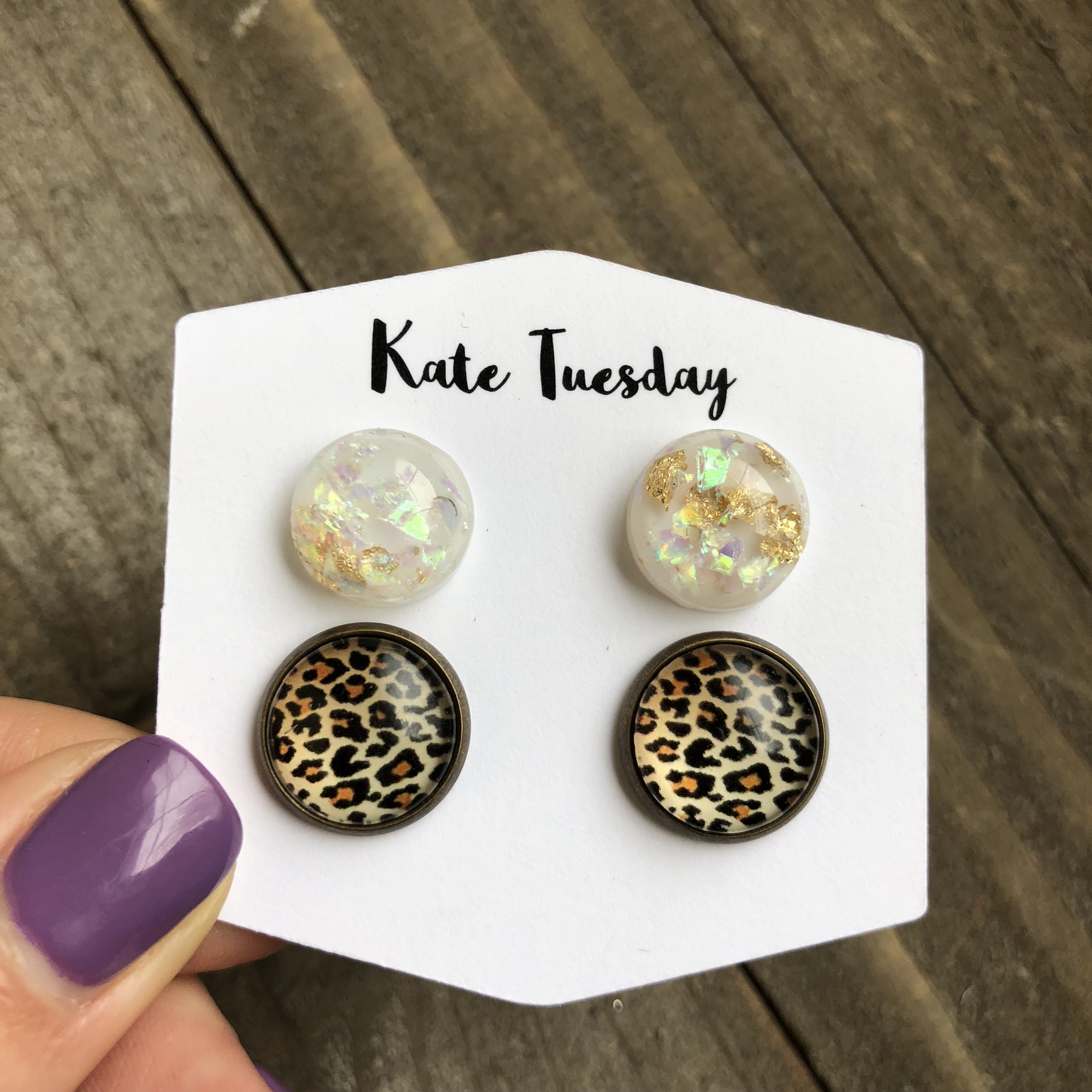 Double earrings featuring white gold flakes and cheetah print in a bronze setting, showcasing a stylish and unique design.