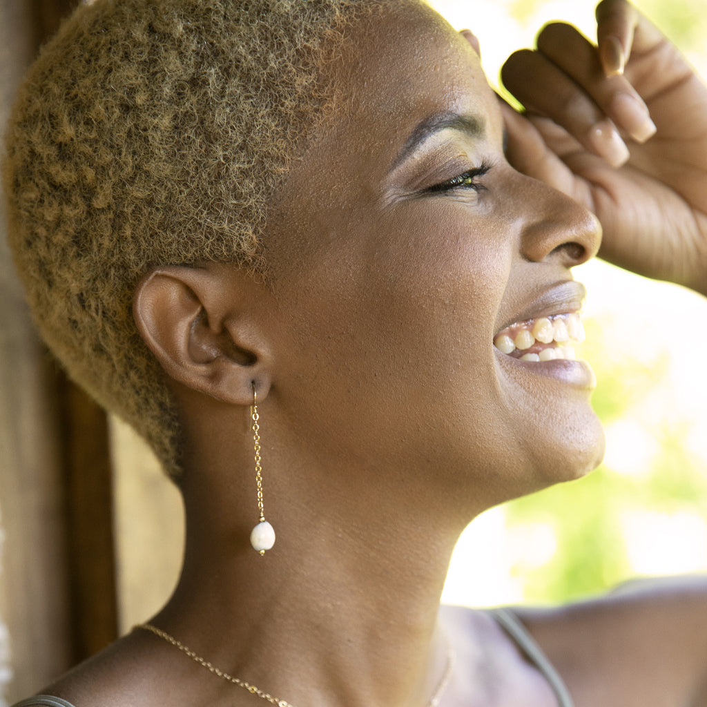 Elegant Elene Teardrop Earrings featuring a 14K gold hook and gold-plated drop chain with a majok seed from Haiti.