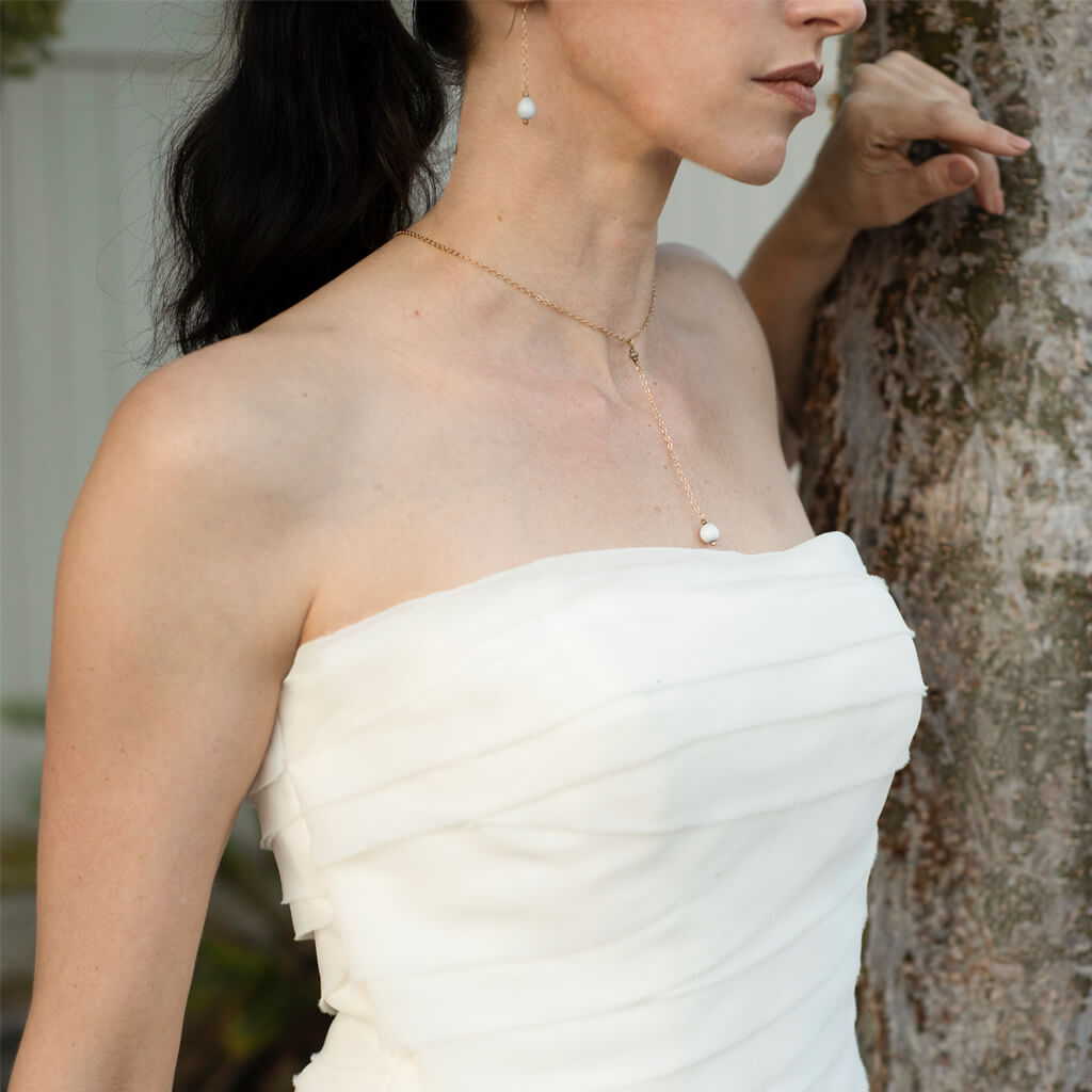 Elegant Elene Teardrop Earrings featuring a 14K gold hook and gold-plated drop chain with a majok seed from Haiti.