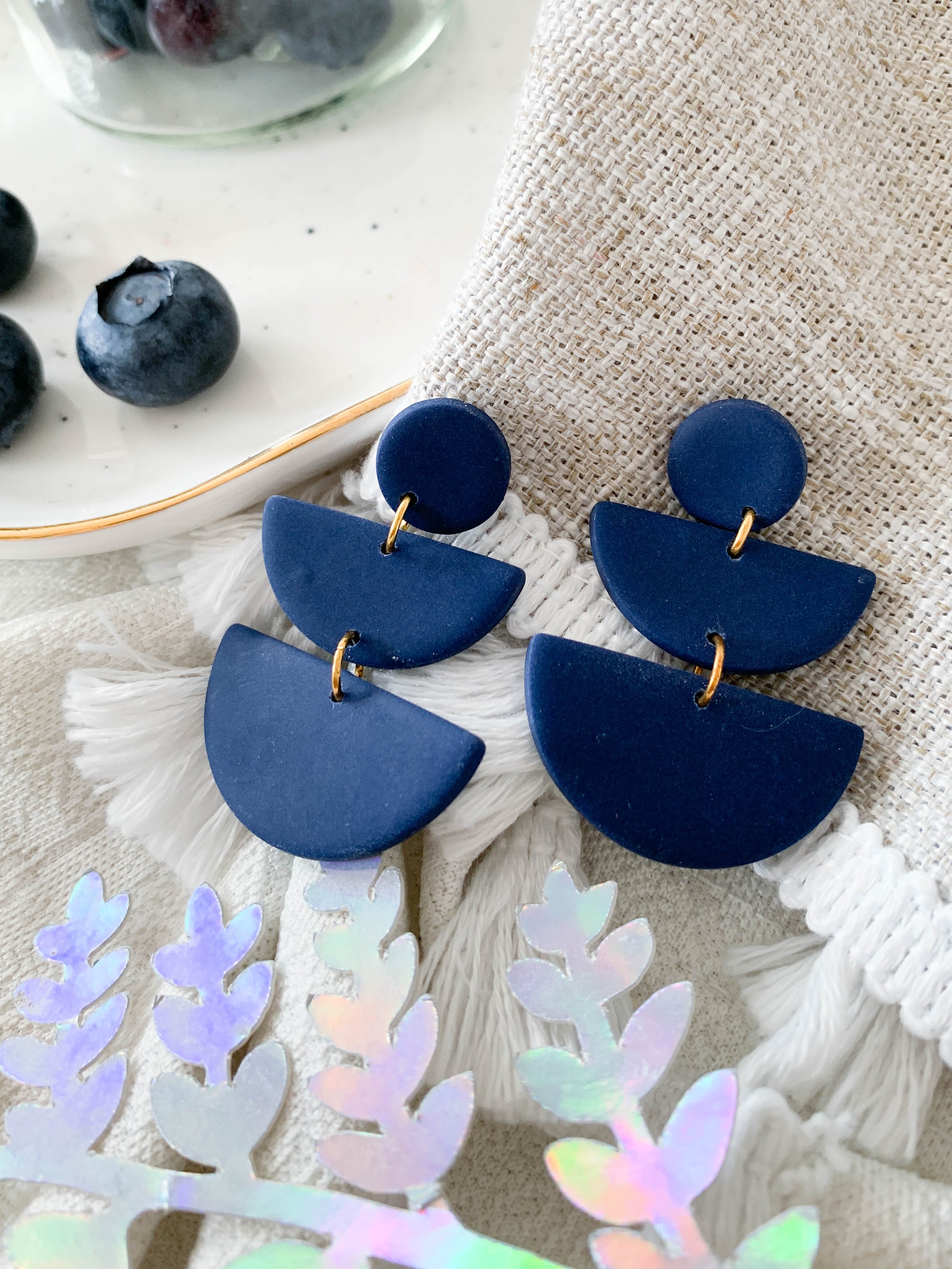 Emily Blueberry earrings featuring a navy semi-circle design, perfect for adding a whimsical touch to any outfit.