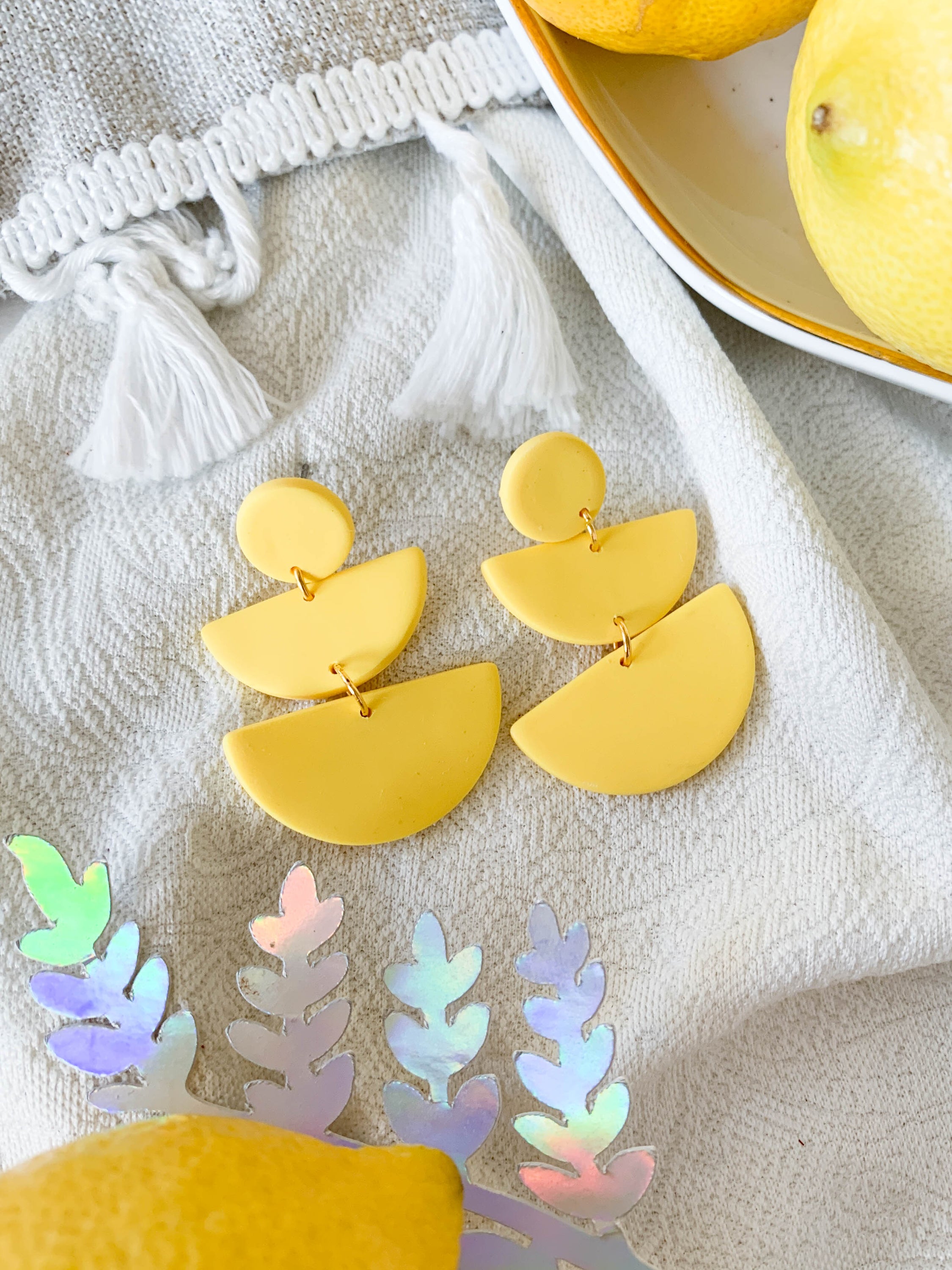 Emily Lemon earrings featuring a vibrant lemon design with surgical steel posts for sensitive ears.