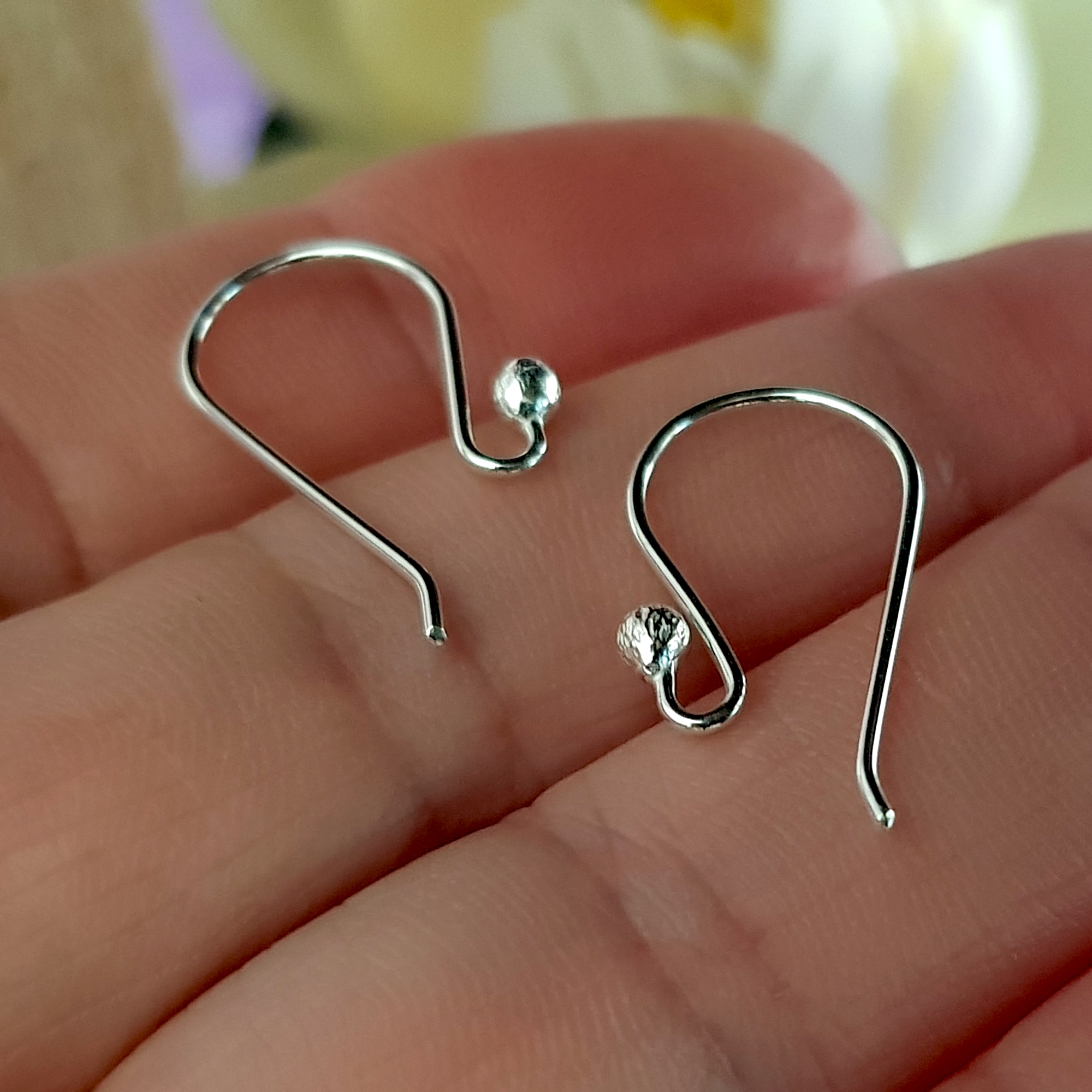 A close-up view of 10 pairs of Euro Style Hooks made from sterling silver, showcasing their elegant design and polished finish.