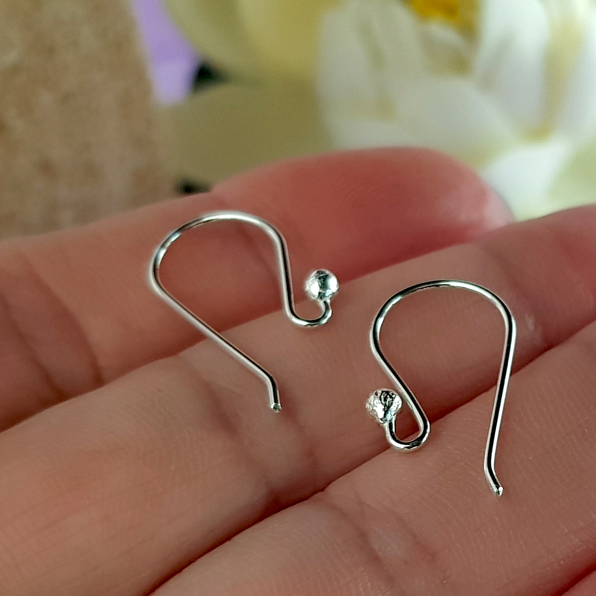 A close-up view of 10 pairs of Euro Style Hooks made from sterling silver, showcasing their elegant design and polished finish.