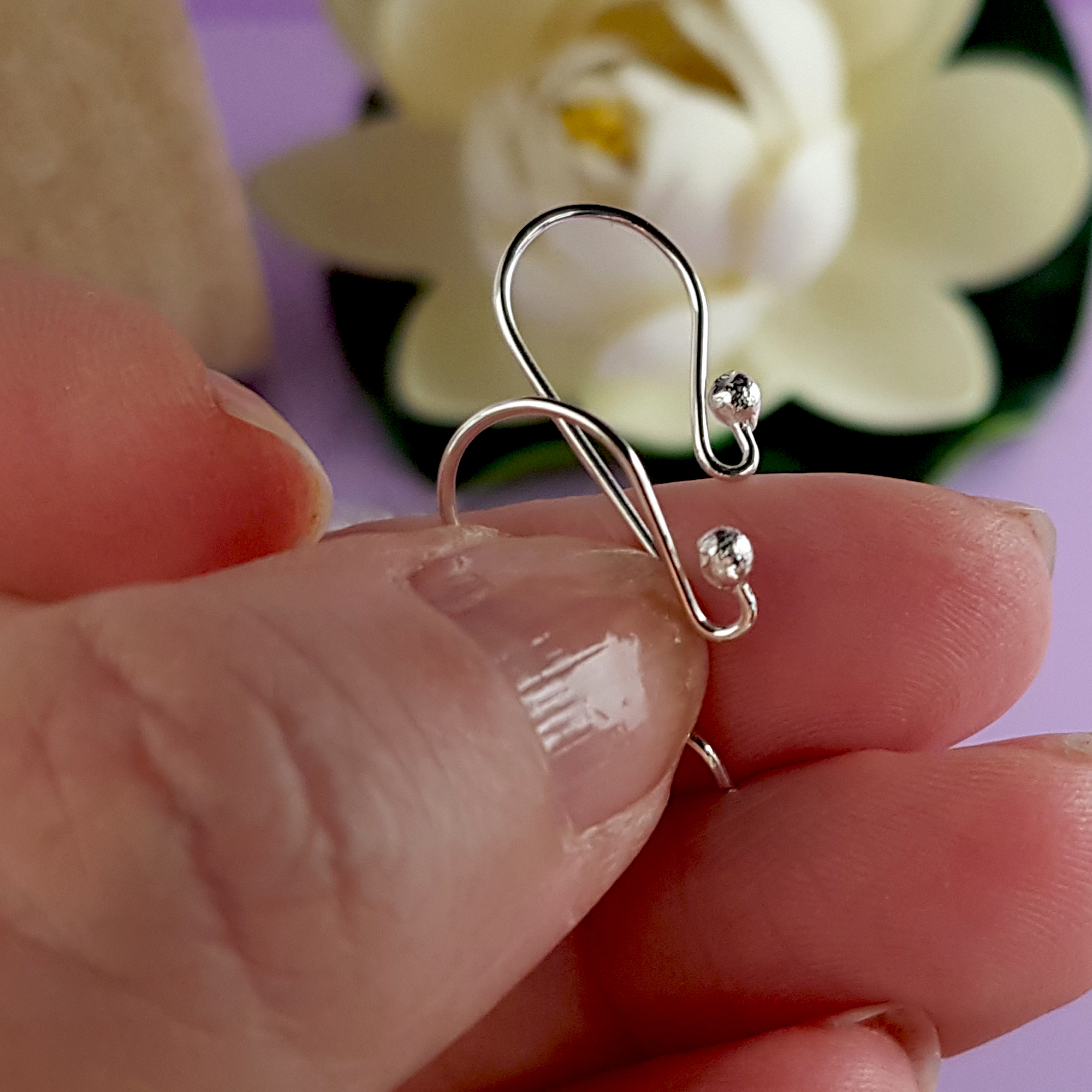 A close-up view of 10 pairs of Euro Style Hooks made from sterling silver, showcasing their elegant design and polished finish.