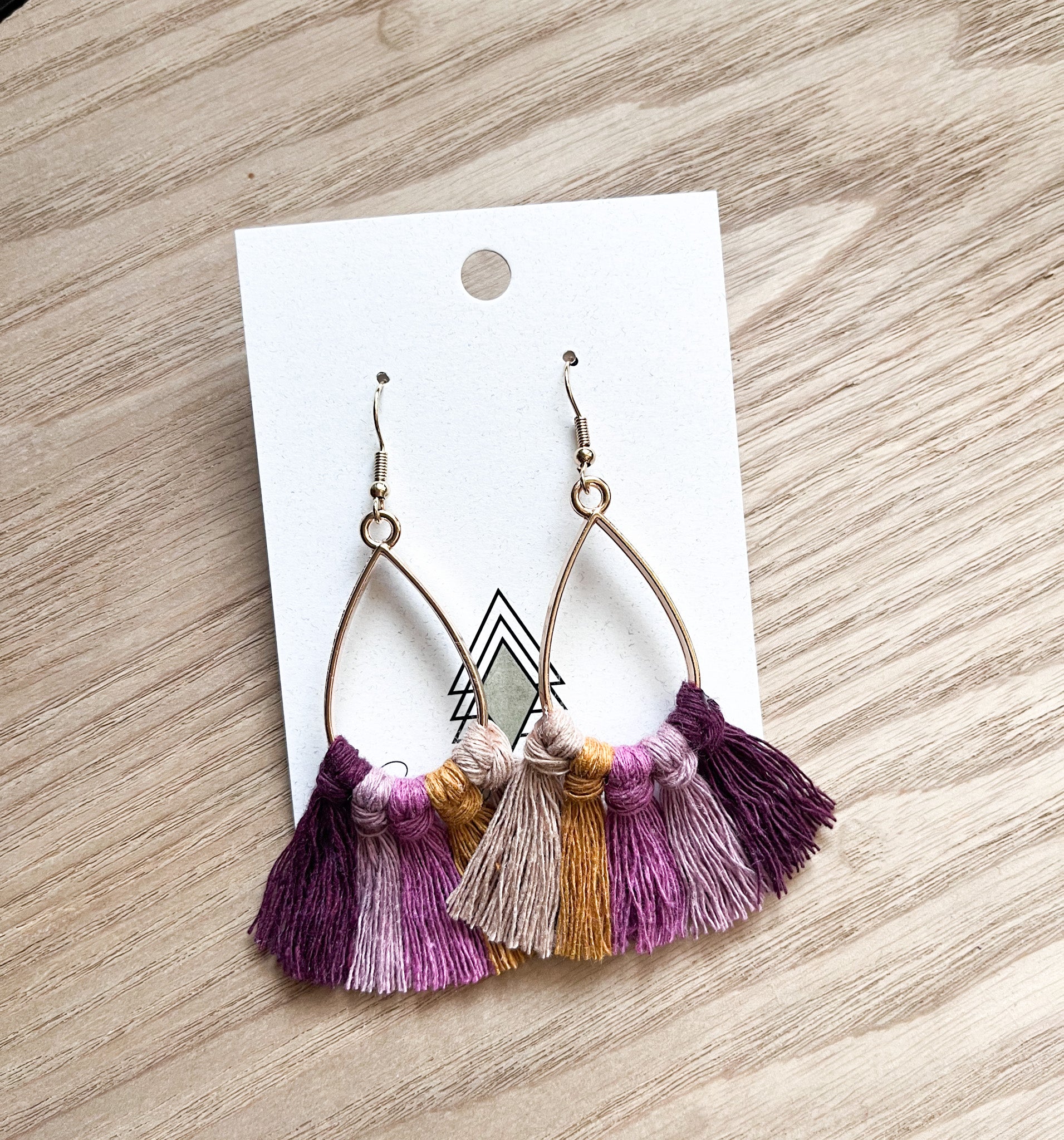 A pair of lightweight macrame earrings in earthy tones, showcasing intricate designs perfect for fall fashion.