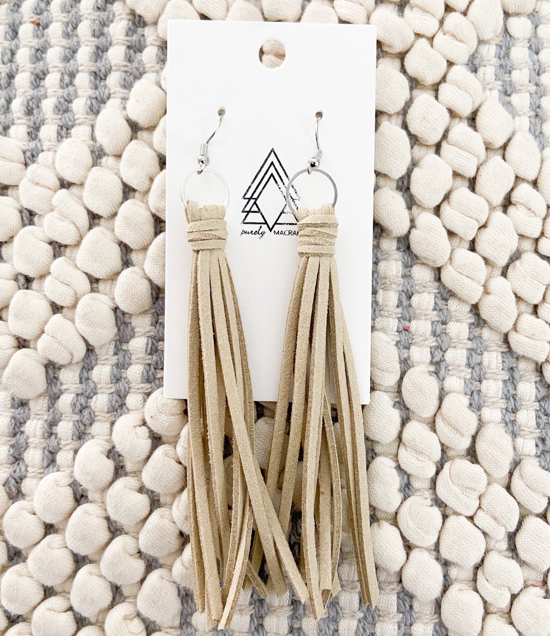 A collection of colorful faux leather tassels hanging elegantly, showcasing their lightweight and stylish design.