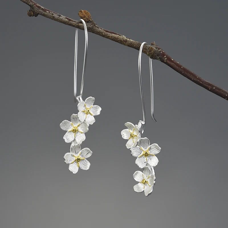 Elegant Forget Me Not Drop Earrings made of 925 sterling silver and 18K gold plating, featuring a beautiful pansy flower design.