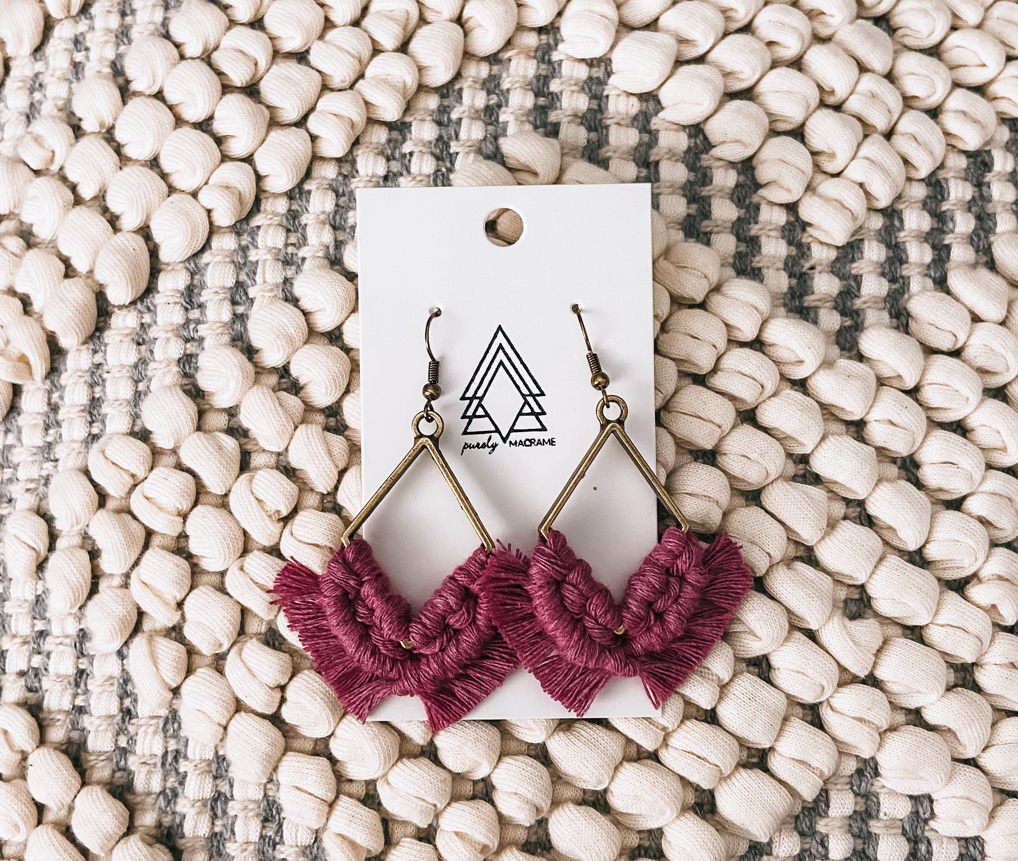 A pair of elegant Fuschia Diamonds made from 100% macrame cotton, showcasing their vibrant color and lightweight design.