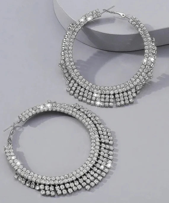 A pair of stunning Glammed Out Diamond Hoops featuring geometric rhinestone design in gold and silver finishes.