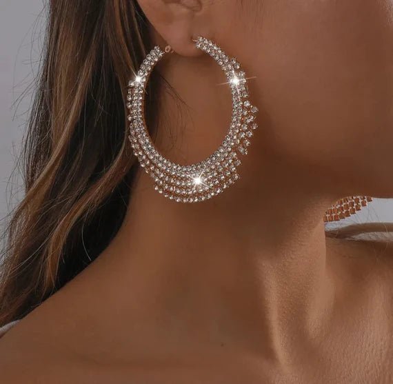 A pair of stunning Glammed Out Diamond Hoops featuring geometric rhinestone design in gold and silver finishes.