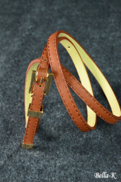 Gold Buckle Belt made of simulated leather with gold-tone hardware, featuring five adjustable holes for a perfect fit.