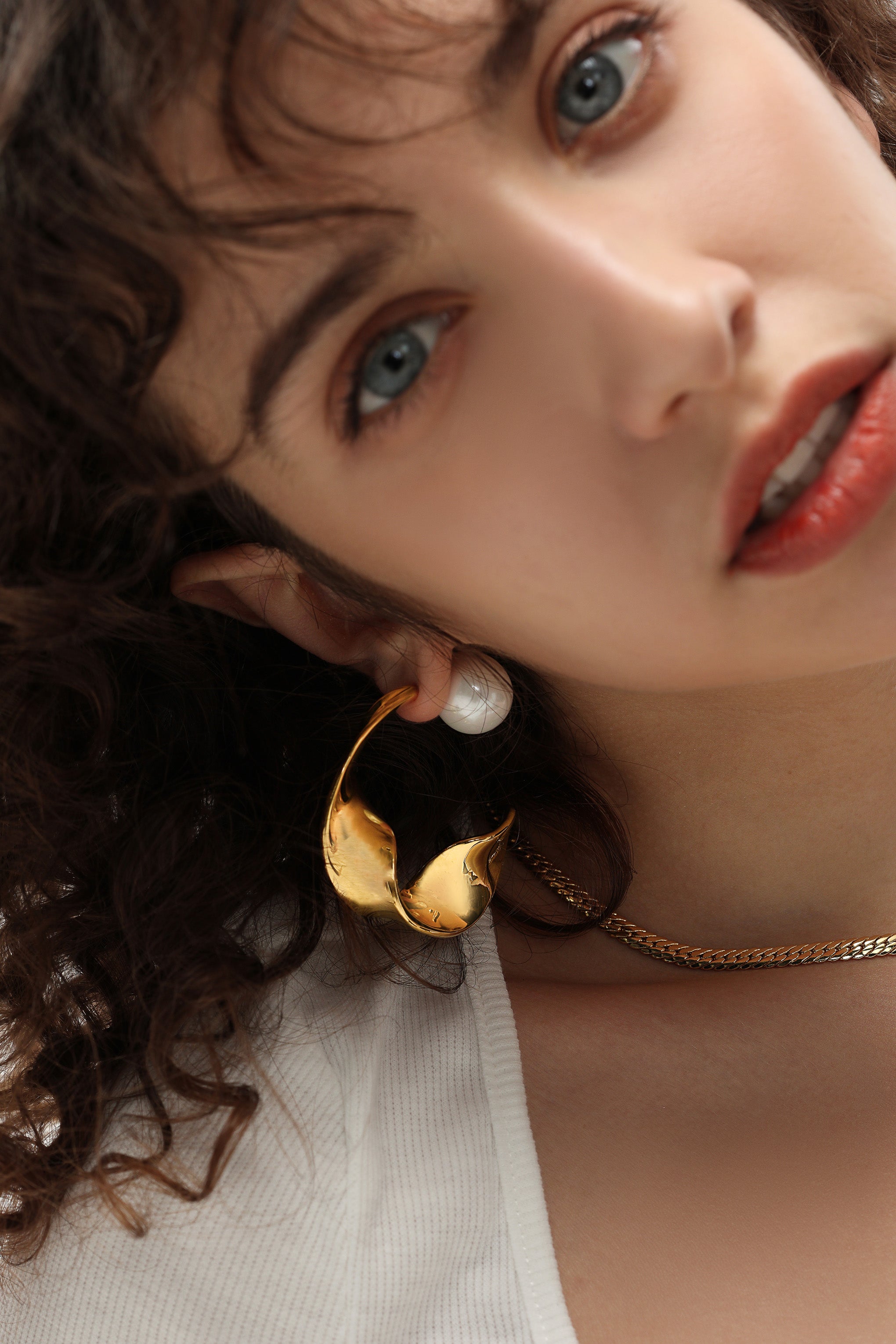 Gold Chunky Wave Hoop Earrings featuring a unique waved design and pearl accents, perfect for any occasion.