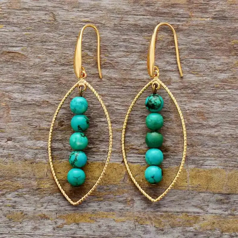 Elegant Gold Leaf Turquoise Dangle Earrings featuring vibrant turquoise stones and intricate gold leaf detailing.