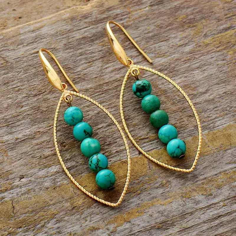 Elegant Gold Leaf Turquoise Dangle Earrings featuring vibrant turquoise stones and intricate gold leaf detailing.