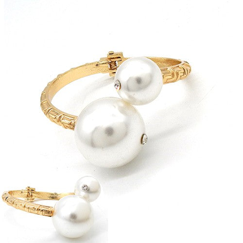 A stylish Greek Key Textured Bracelet featuring a hinged pearl, showcasing intricate metalwork and elegant design.