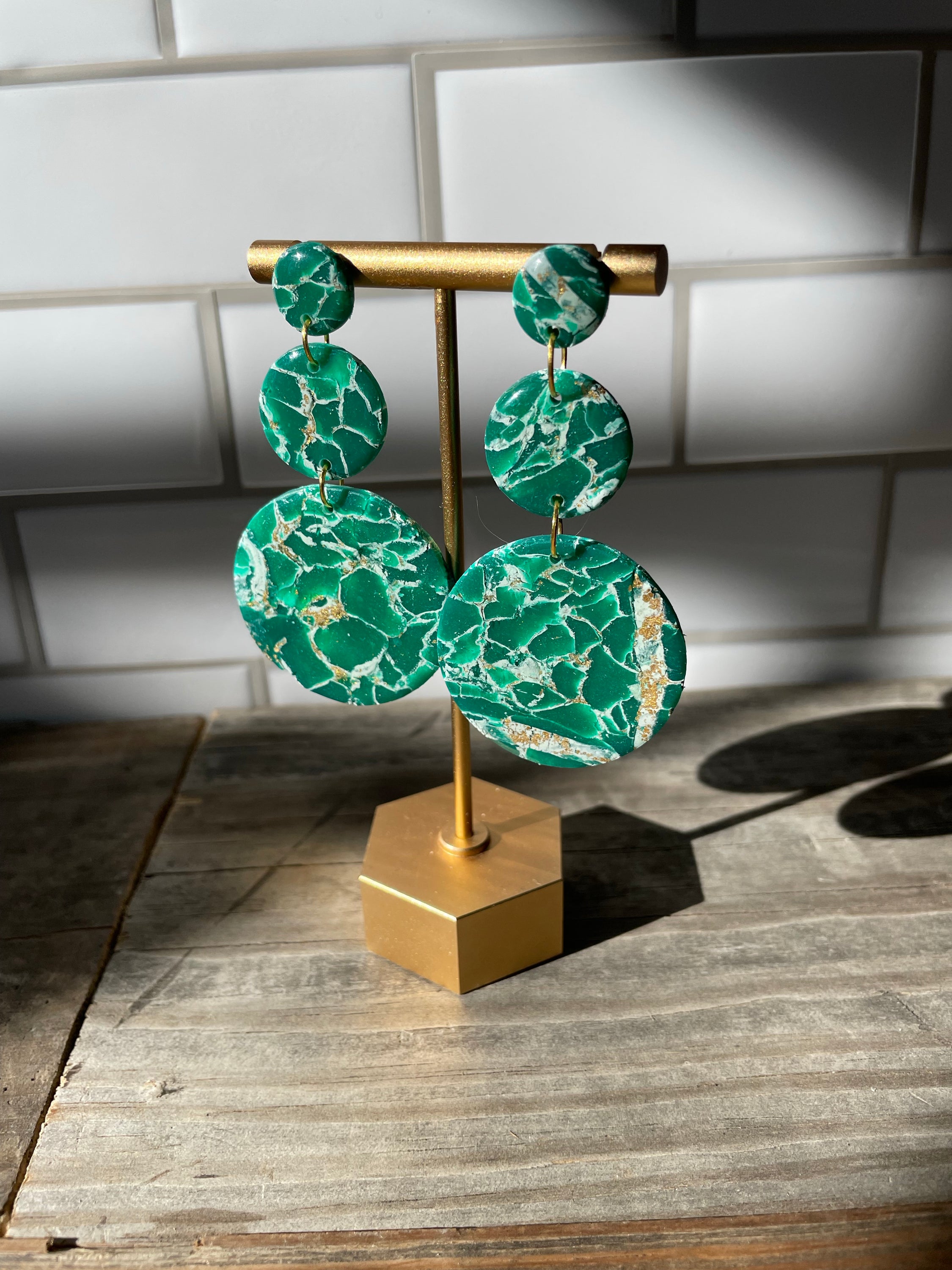 A pair of handmade green marble statement earrings featuring unique patterns and lightweight design, perfect for bold fashion statements.