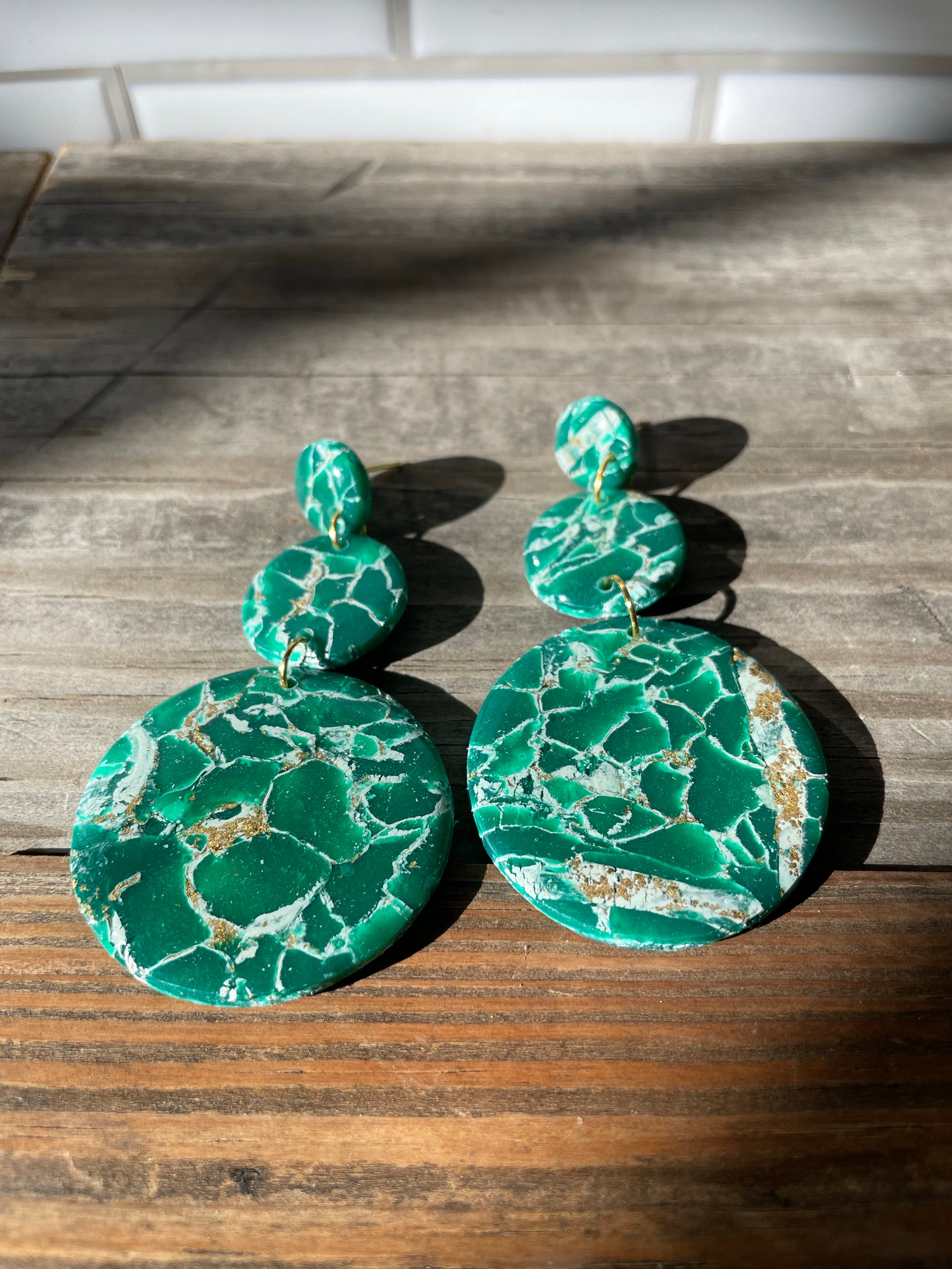 A pair of handmade green marble statement earrings featuring unique patterns and lightweight design, perfect for bold fashion statements.