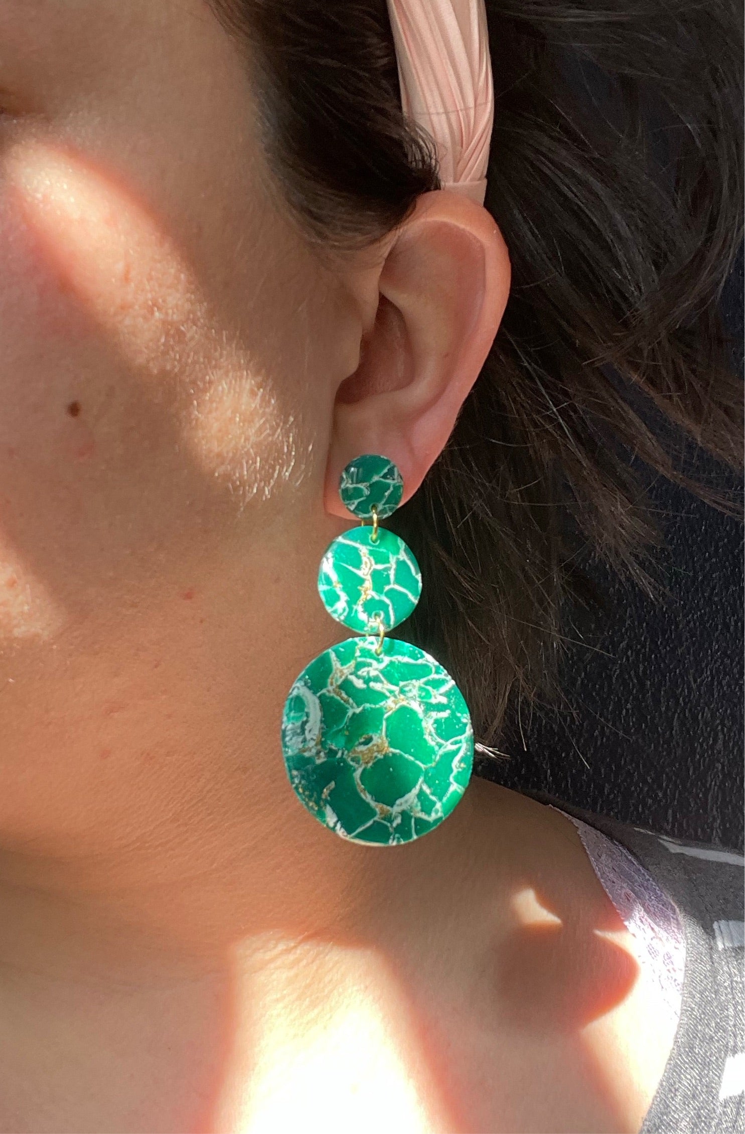 A pair of handmade green marble statement earrings featuring unique patterns and lightweight design, perfect for bold fashion statements.