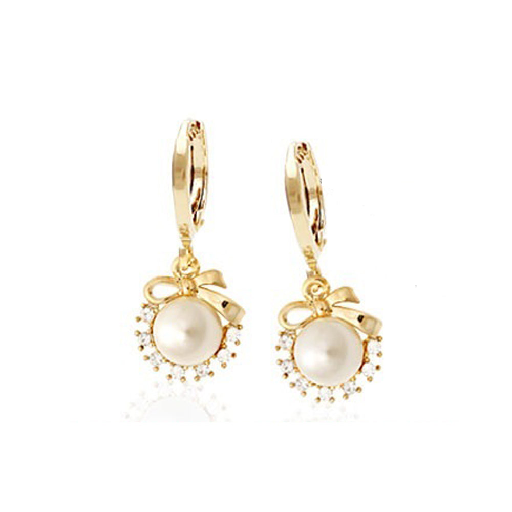 Elegant Hallie Bow Pearl Earrings featuring crystals and a 14K gold pin, designed for sensitive ears.