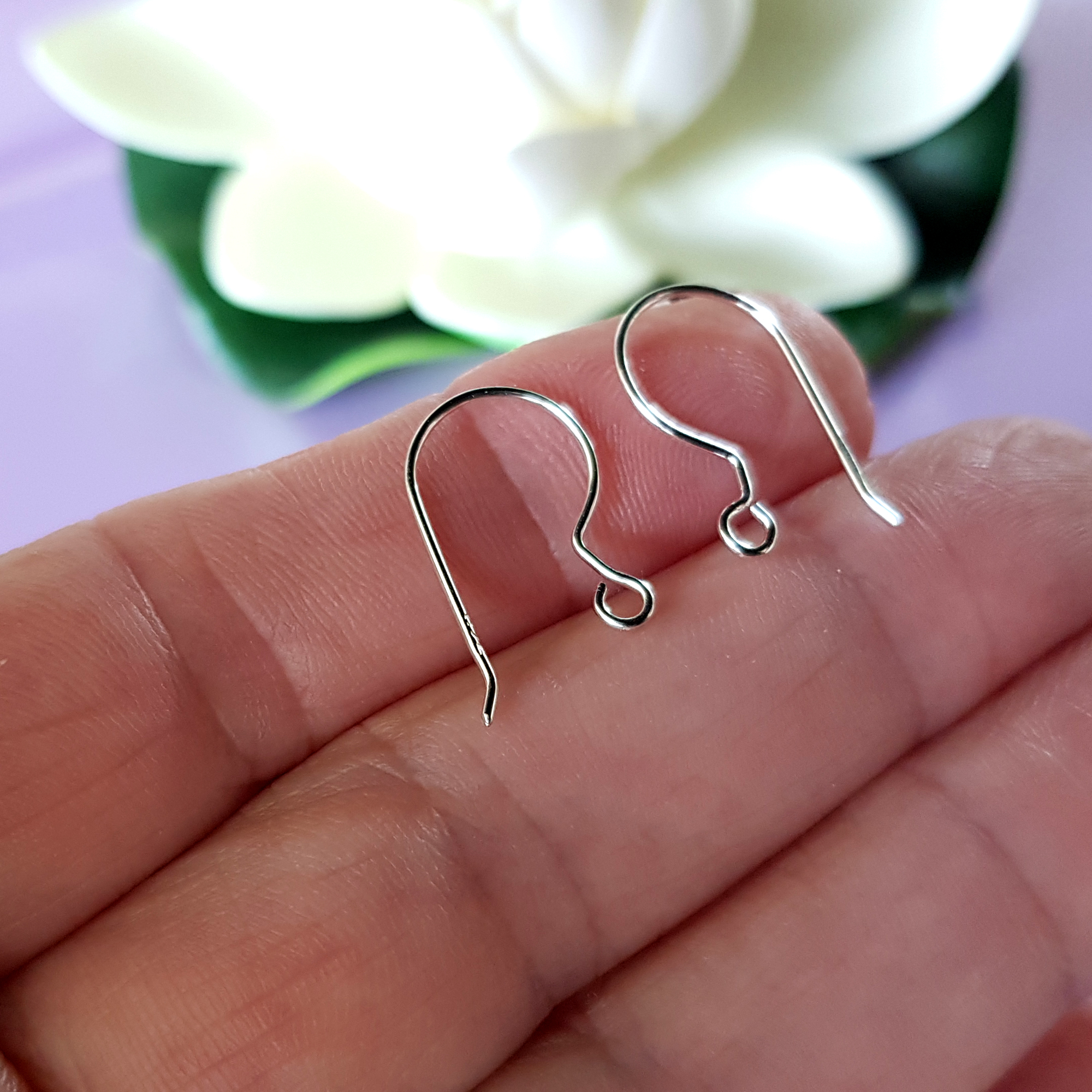 A pair of handcrafted fish hook ear wires made from Sterling Silver 925, featuring a simple loop design for easy wear and comfort.