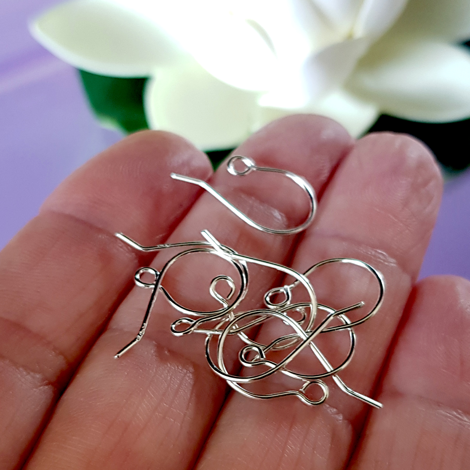 A pair of handcrafted fish hook ear wires made from Sterling Silver 925, featuring a simple loop design for easy wear and comfort.