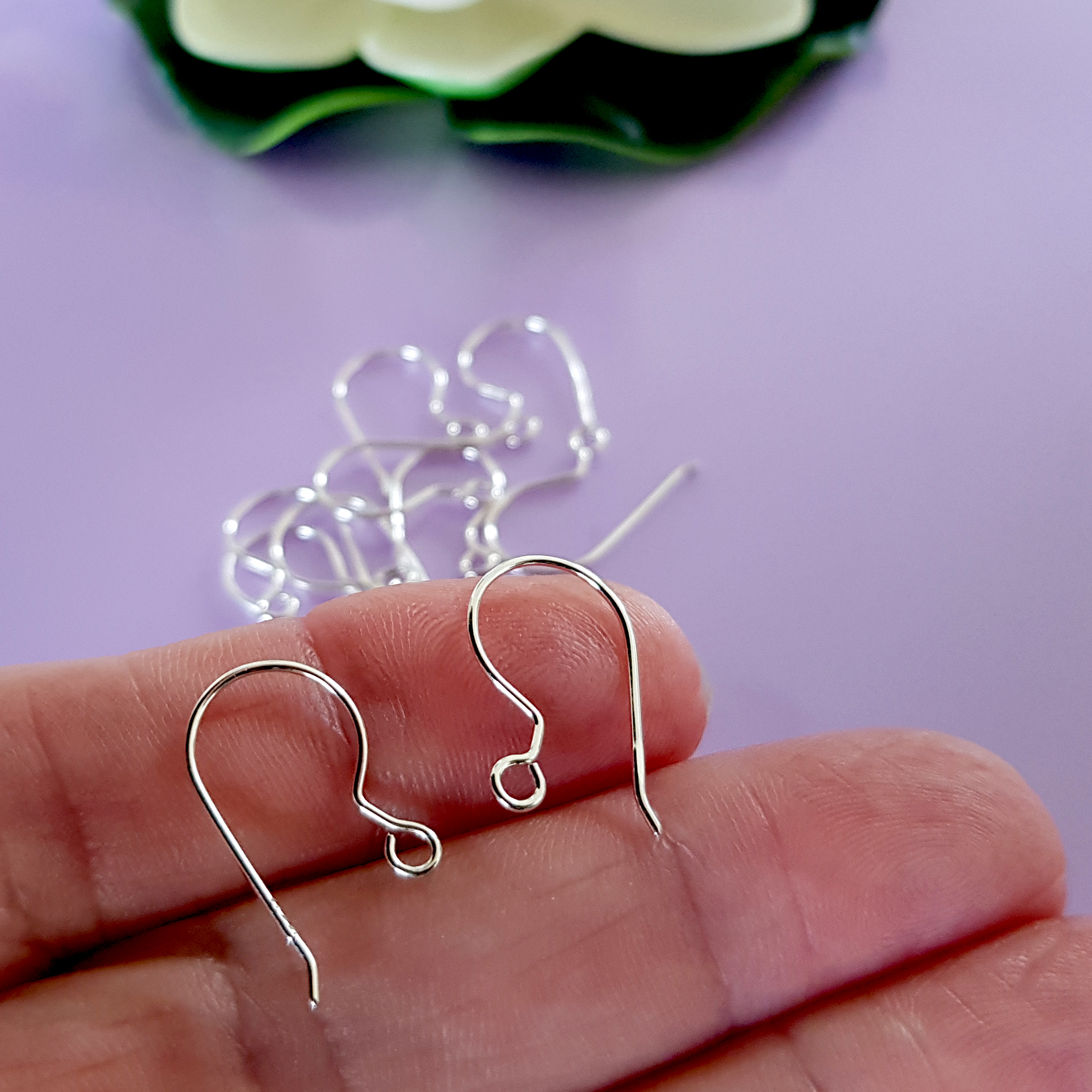 A pair of handcrafted fish hook ear wires made from Sterling Silver 925, featuring a simple loop design for easy wear and comfort.