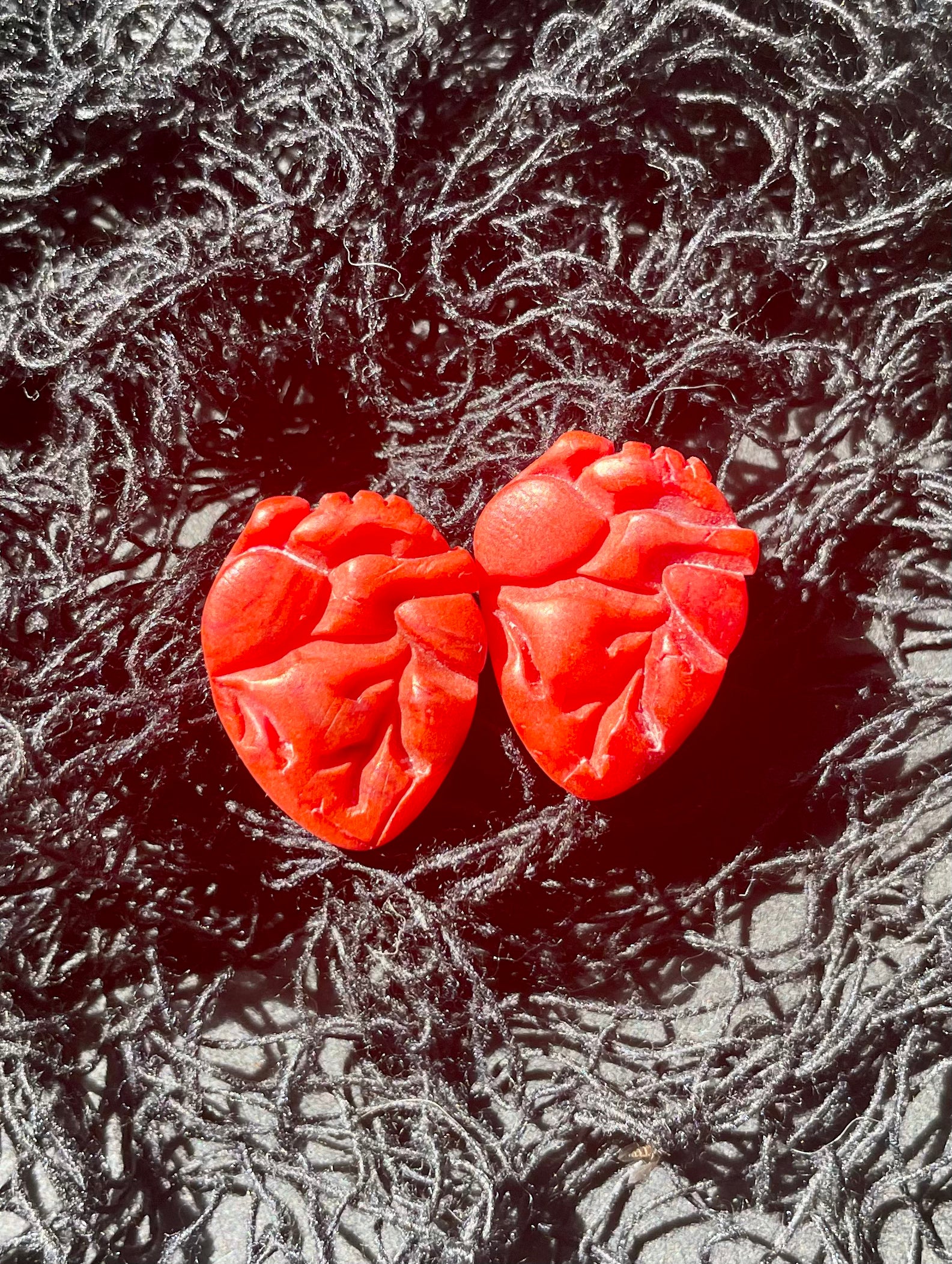 A pair of handmade Heart Attack Studs earrings featuring unique colors and patterns, designed for bold and unique style.