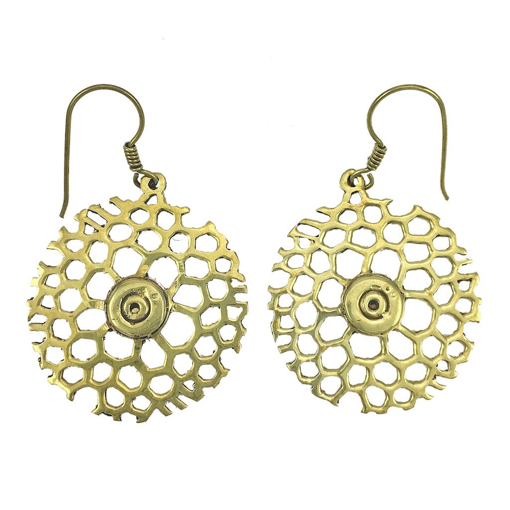 A pair of Honeycomb Bomb Earrings made from recycled brass bomb shells, featuring a bullet fragment at the center, showcasing a unique honeycomb design.