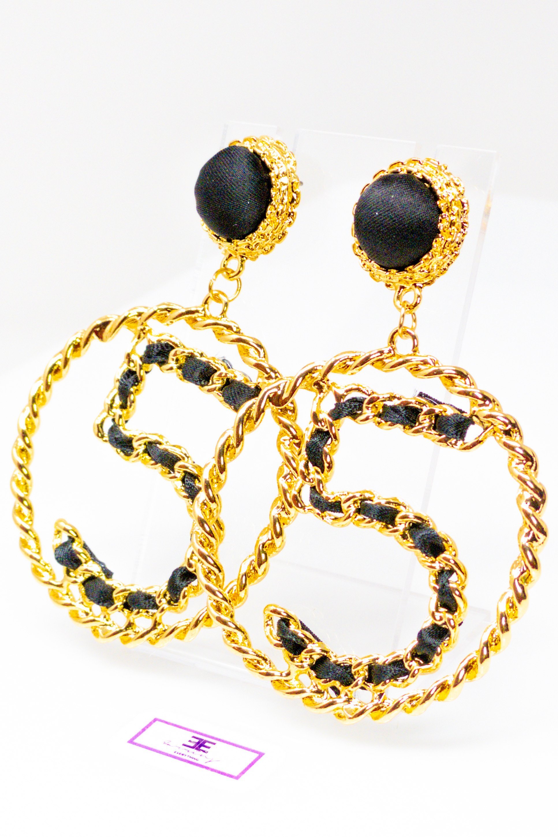 Elegant gold drop hoop earrings made from satin ribbon and brass, featuring a unique geometric design.