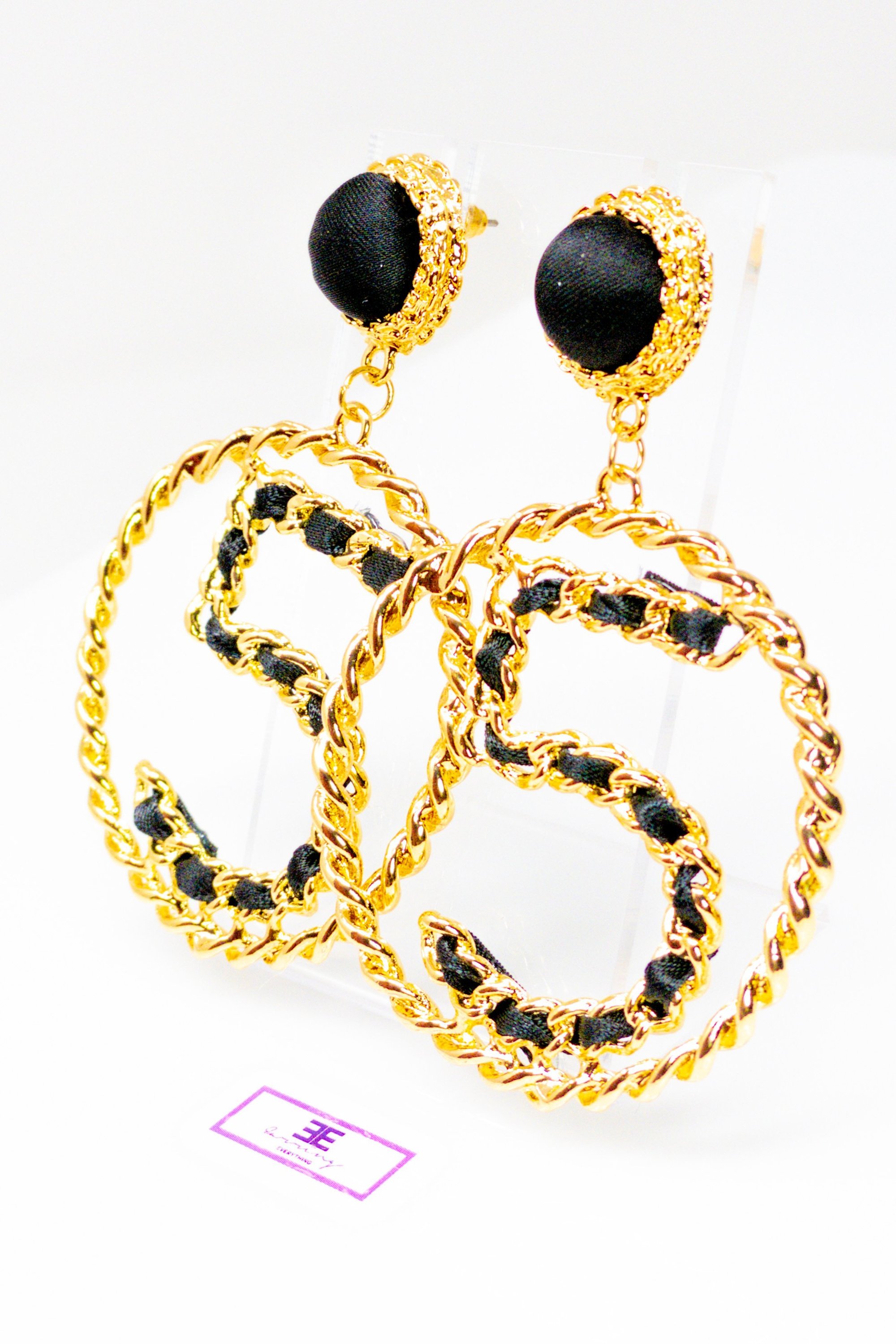 Elegant gold drop hoop earrings made from satin ribbon and brass, featuring a unique geometric design.