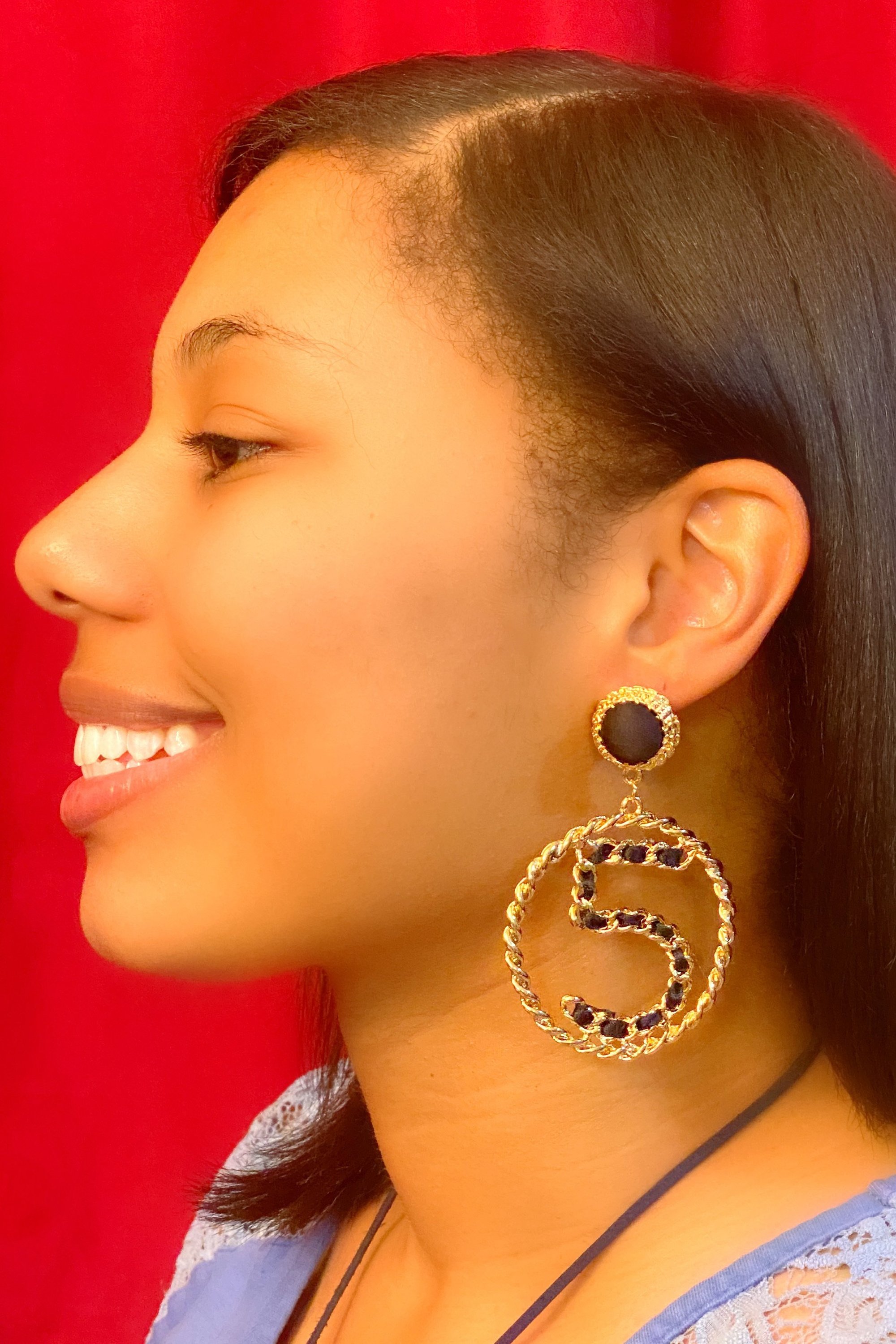 Elegant gold drop hoop earrings made from satin ribbon and brass, featuring a unique geometric design.