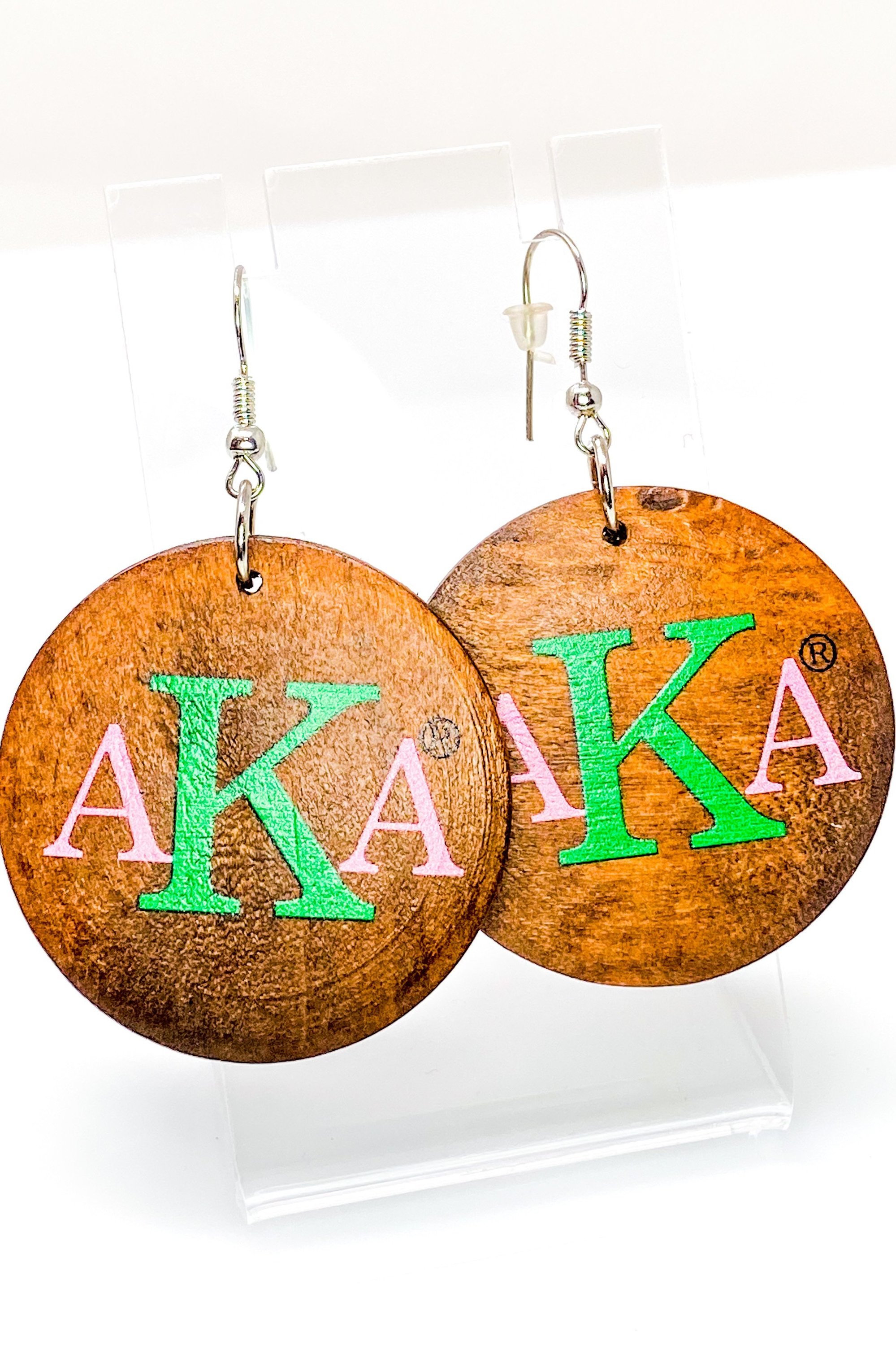 A pair of stylish black wooden monogrammed drop earrings featuring a round shape and front and back print design.