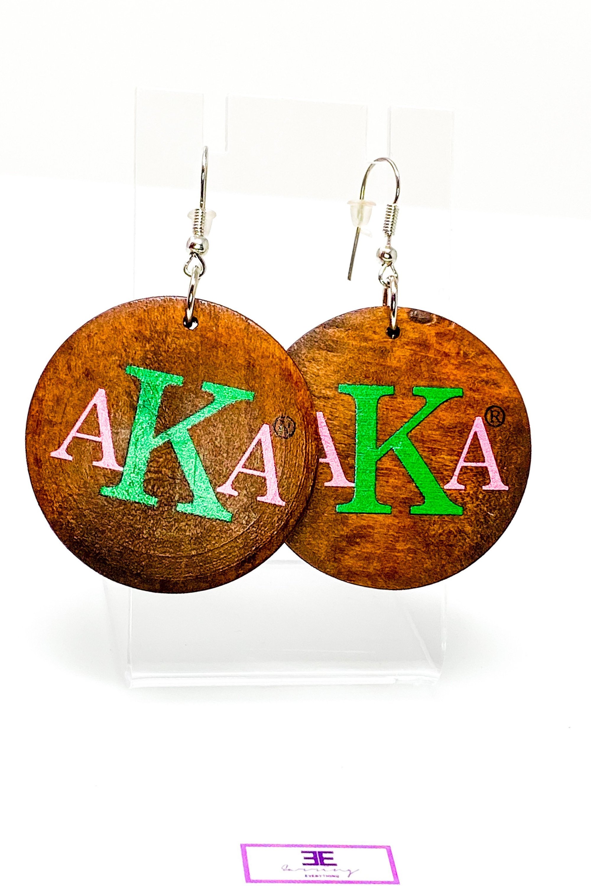 A pair of stylish black wooden monogrammed drop earrings featuring a round shape and front and back print design.