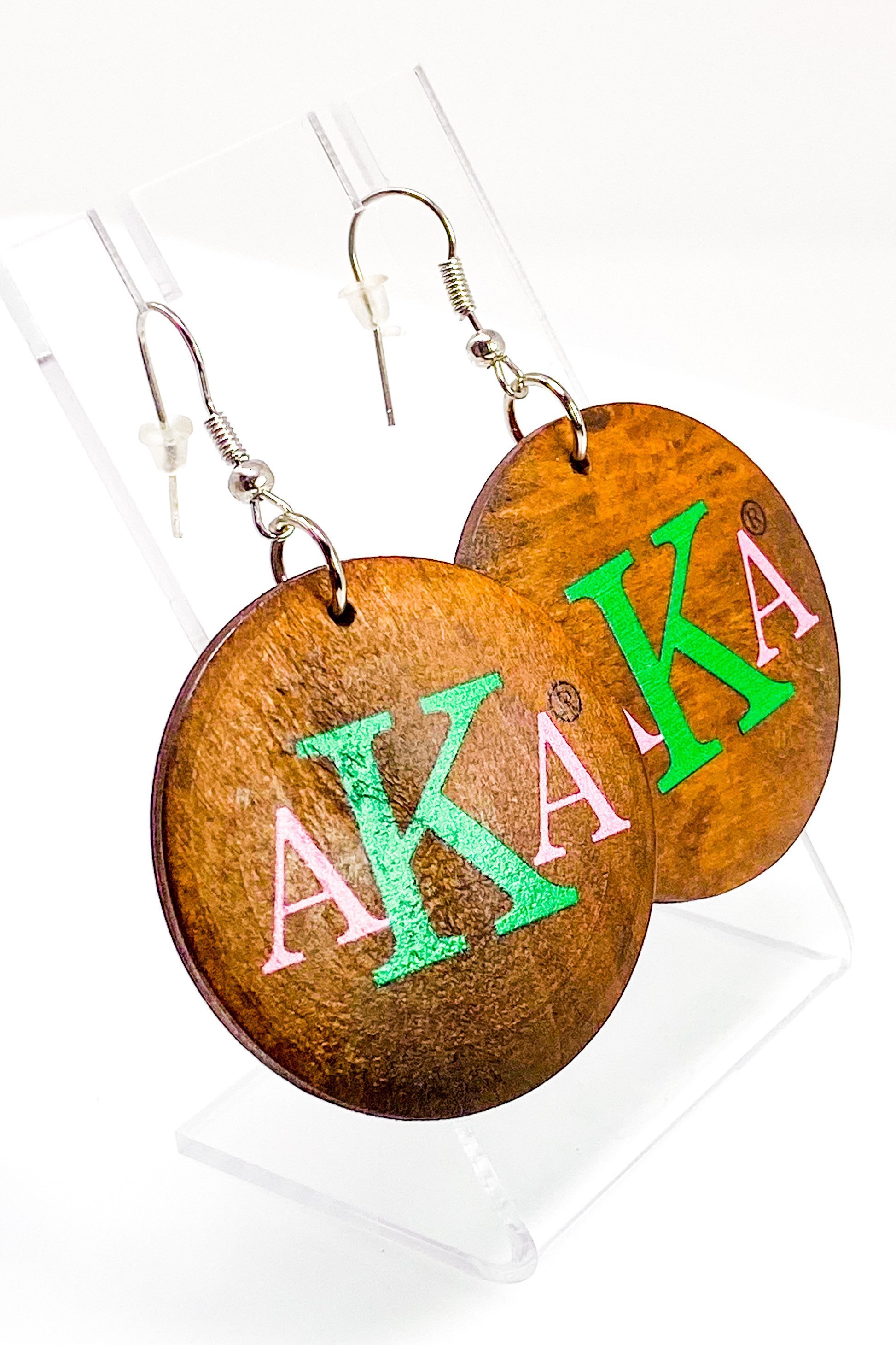 A pair of stylish black wooden monogrammed drop earrings featuring a round shape and front and back print design.