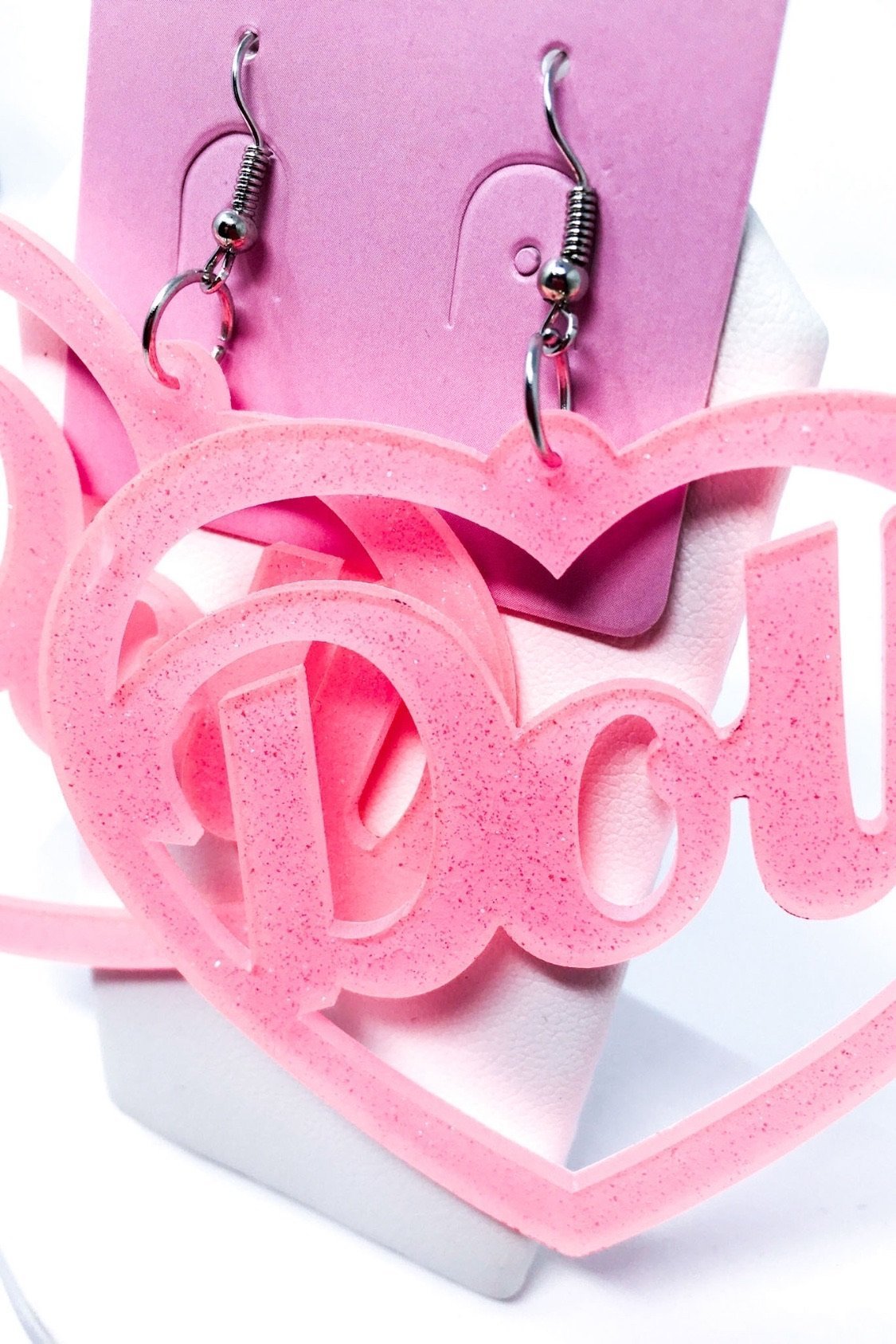 Hoops Doll Earrings featuring a vibrant pink color and sparkle drop design, made from high-quality acrylic.