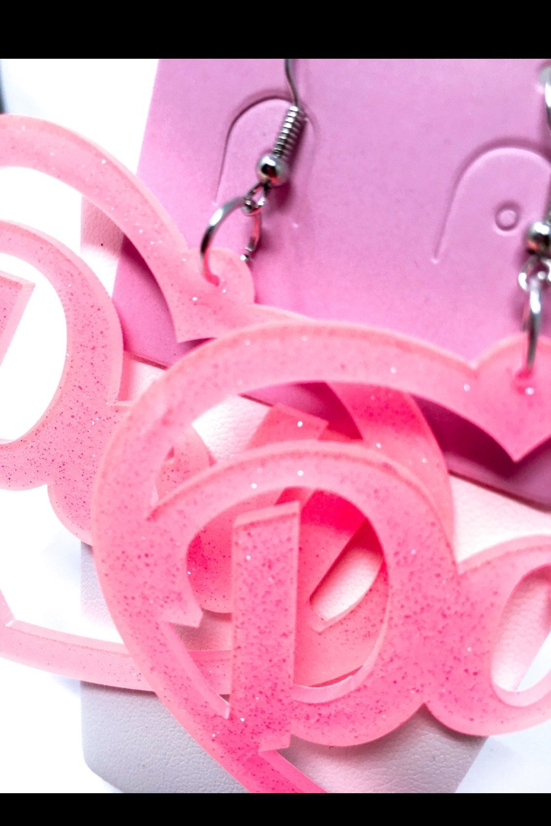 Hoops Doll Earrings featuring a vibrant pink color and sparkle drop design, made from high-quality acrylic.