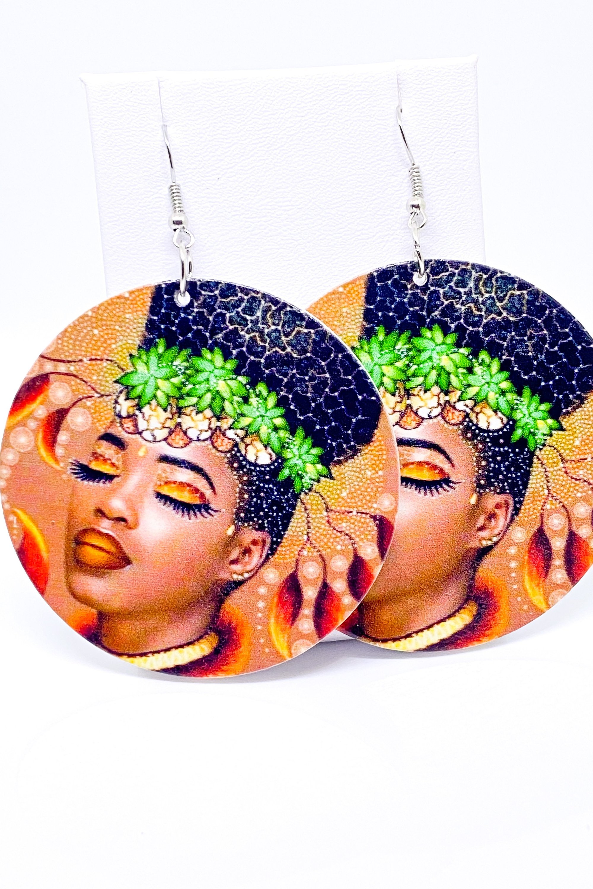 Colorful earrings with woman's face.