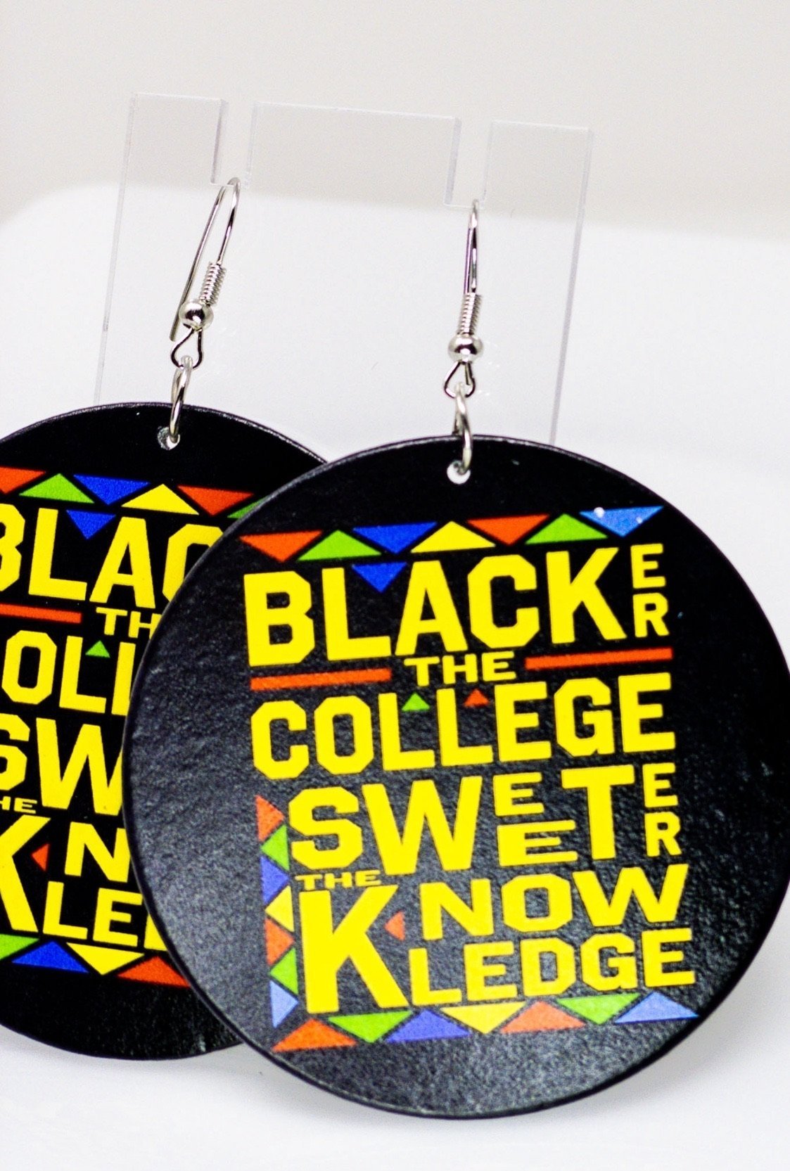 Handmade wooden hoop earrings in black and yellow, featuring nickel-free brass ear hooks, showcasing cultural pride.