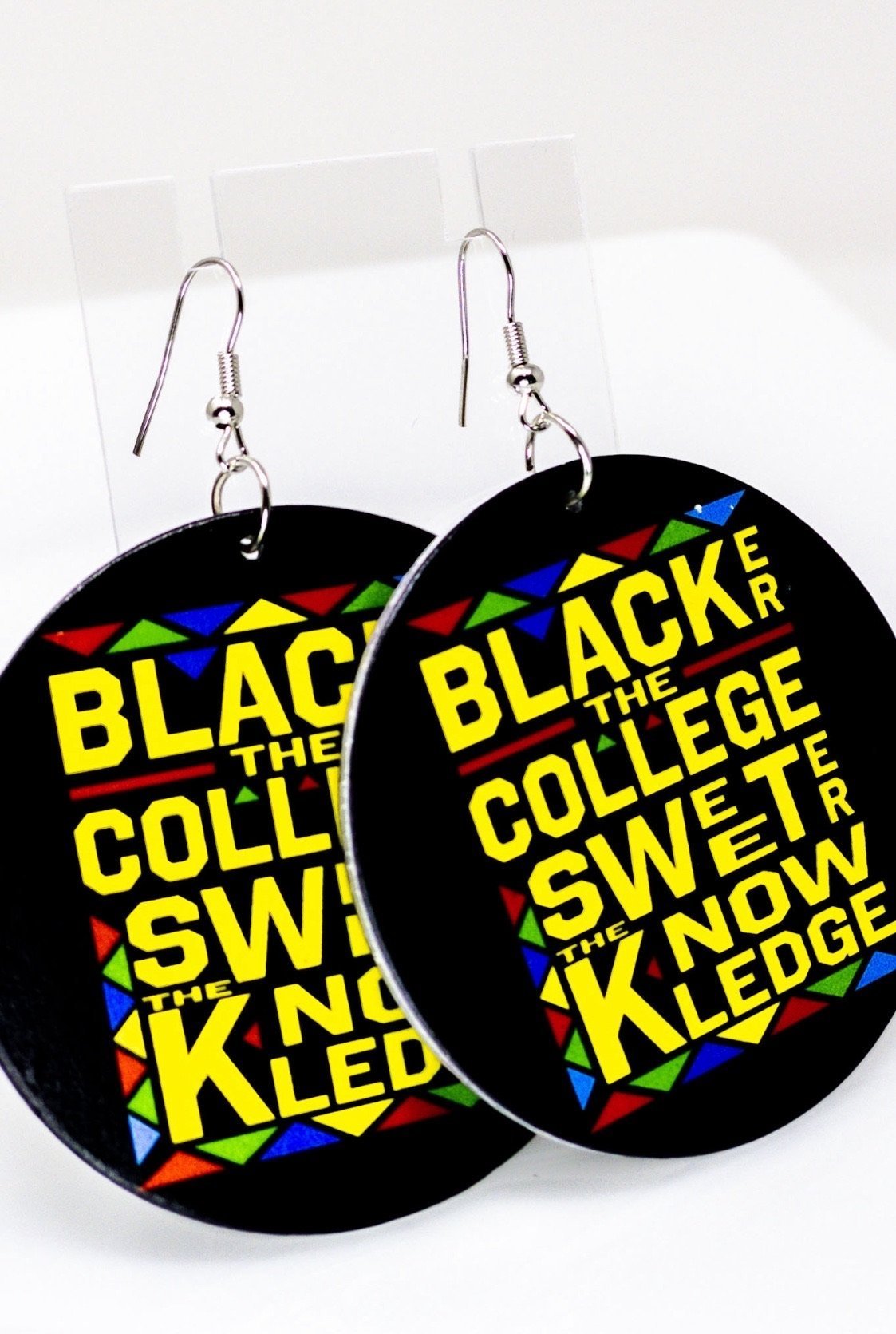 Handmade wooden hoop earrings in black and yellow, featuring nickel-free brass ear hooks, showcasing cultural pride.