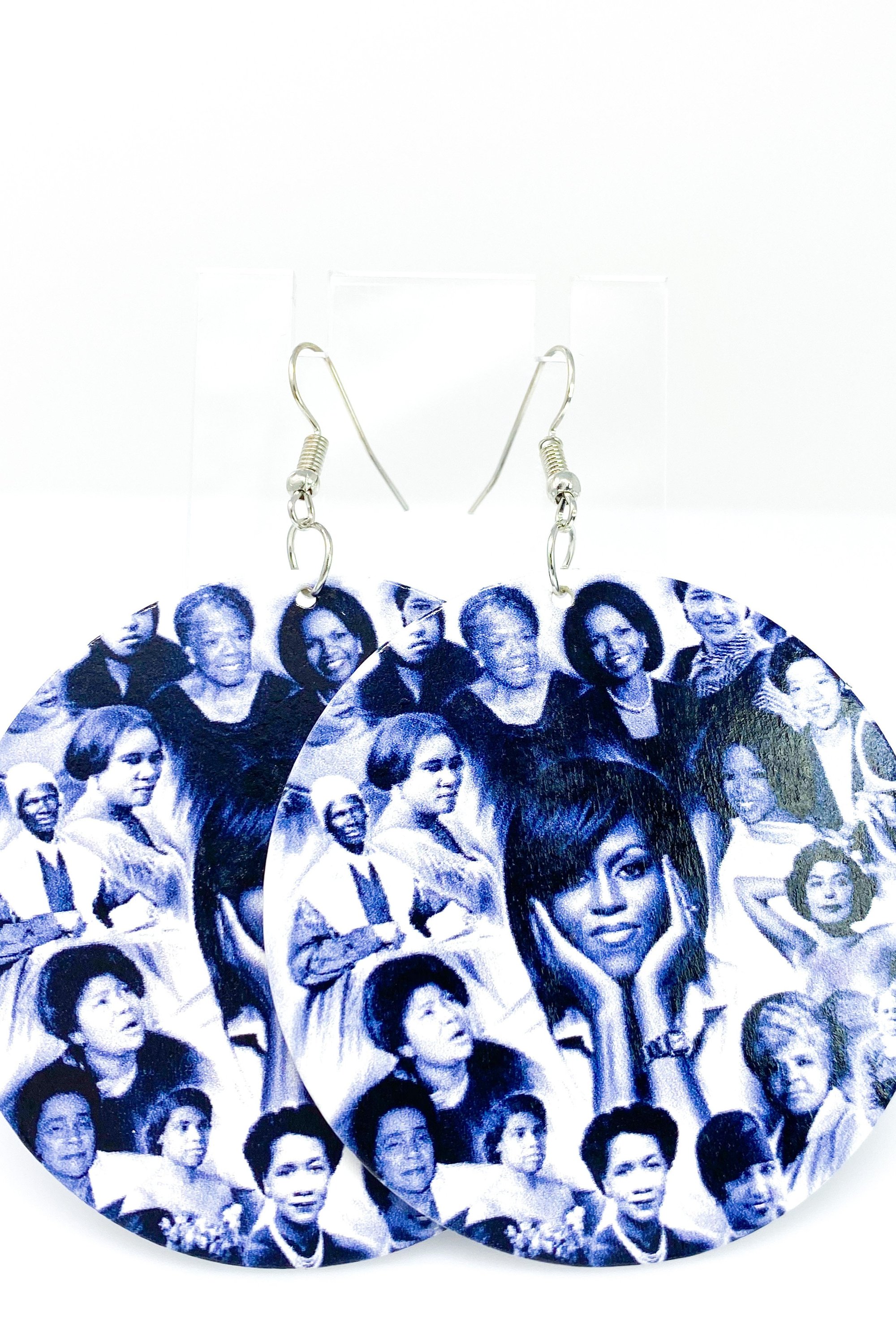 Hoops - Her Legacy earrings featuring a round wooden design with brass ear hooks, available in black and white colors.