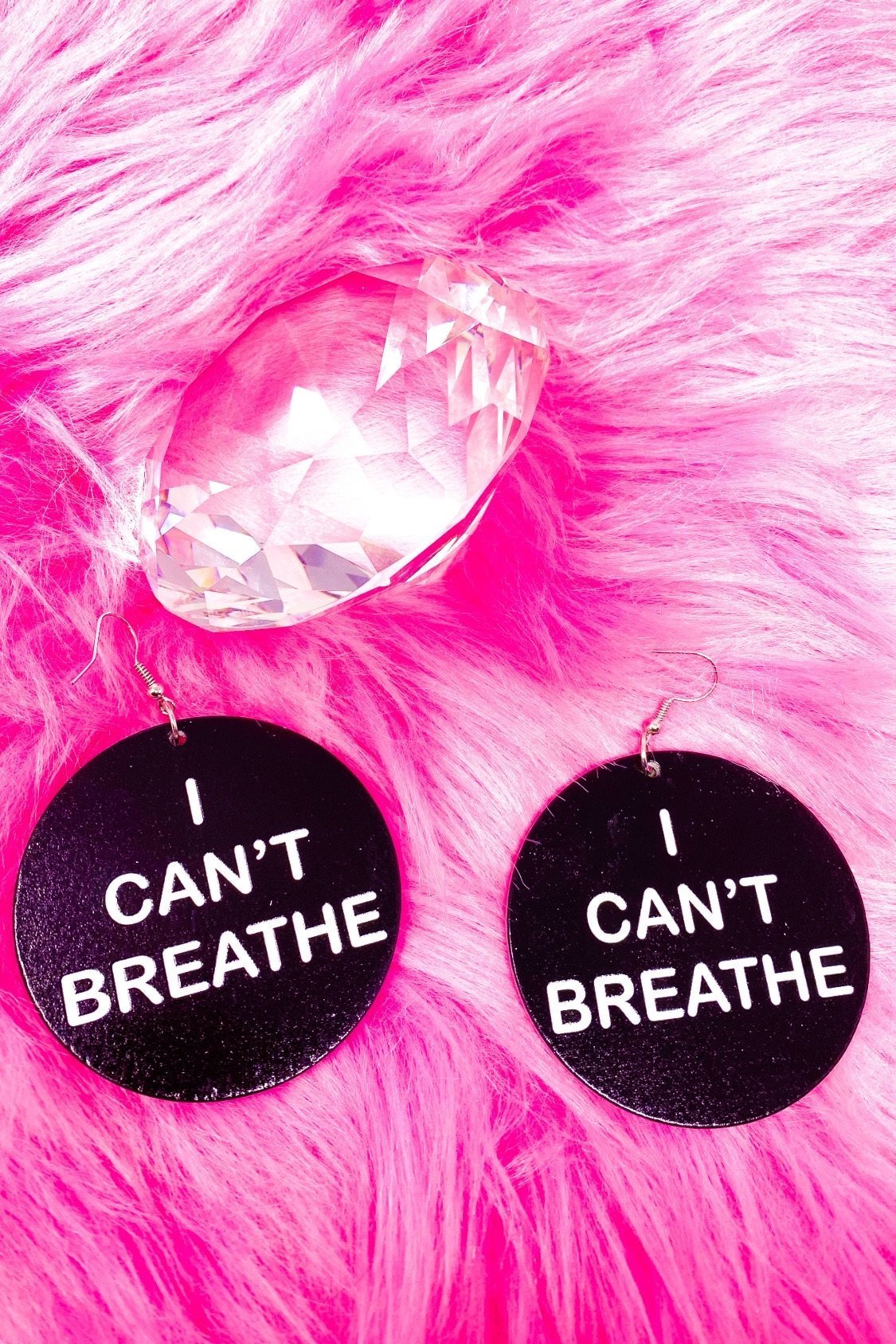 Hoops - I Can’t Breathe earrings featuring a round wooden design with a black print, showcasing their cultural and stylish appeal.