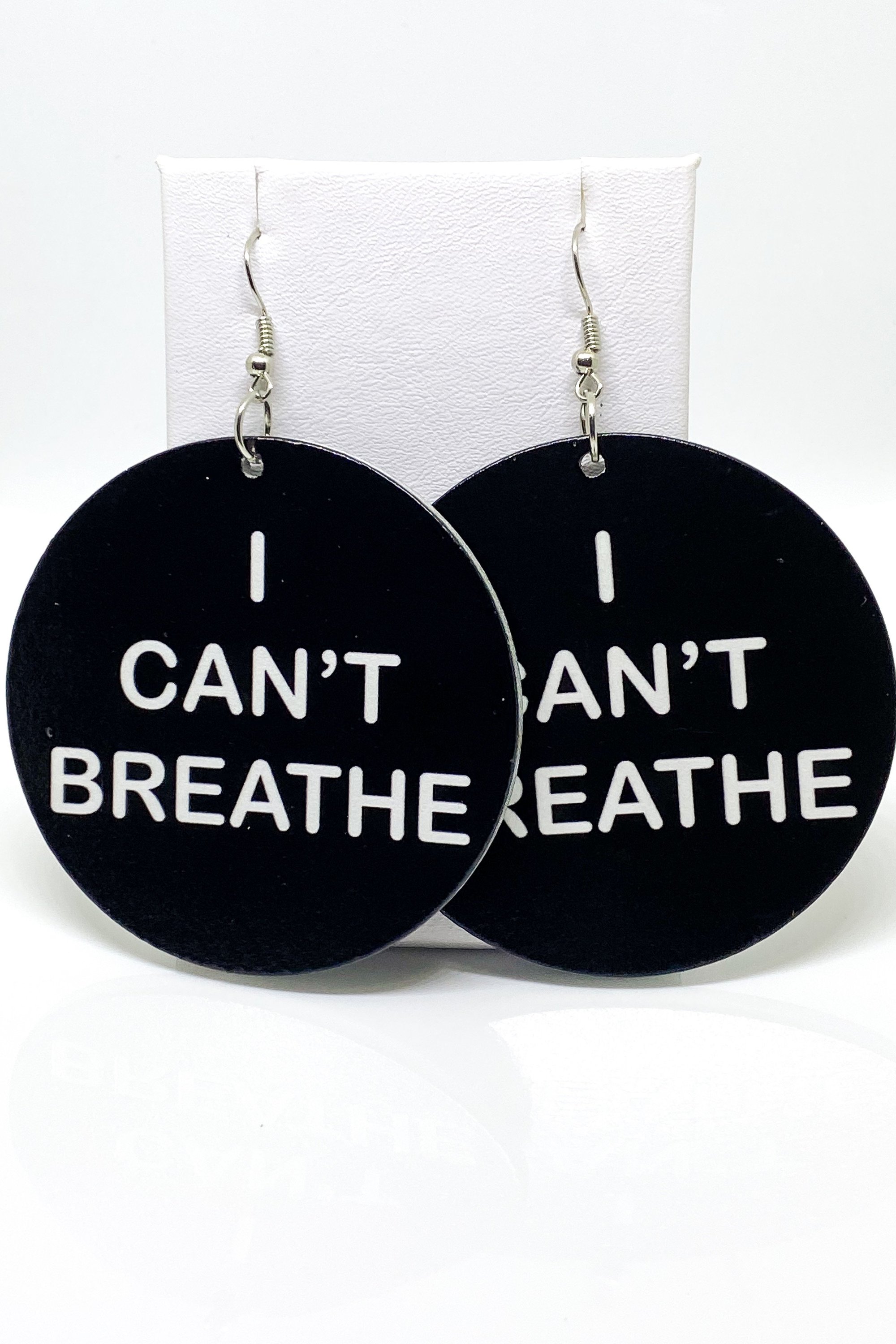 Hoops - I Can’t Breathe earrings featuring a round wooden design with a black print, showcasing their cultural and stylish appeal.