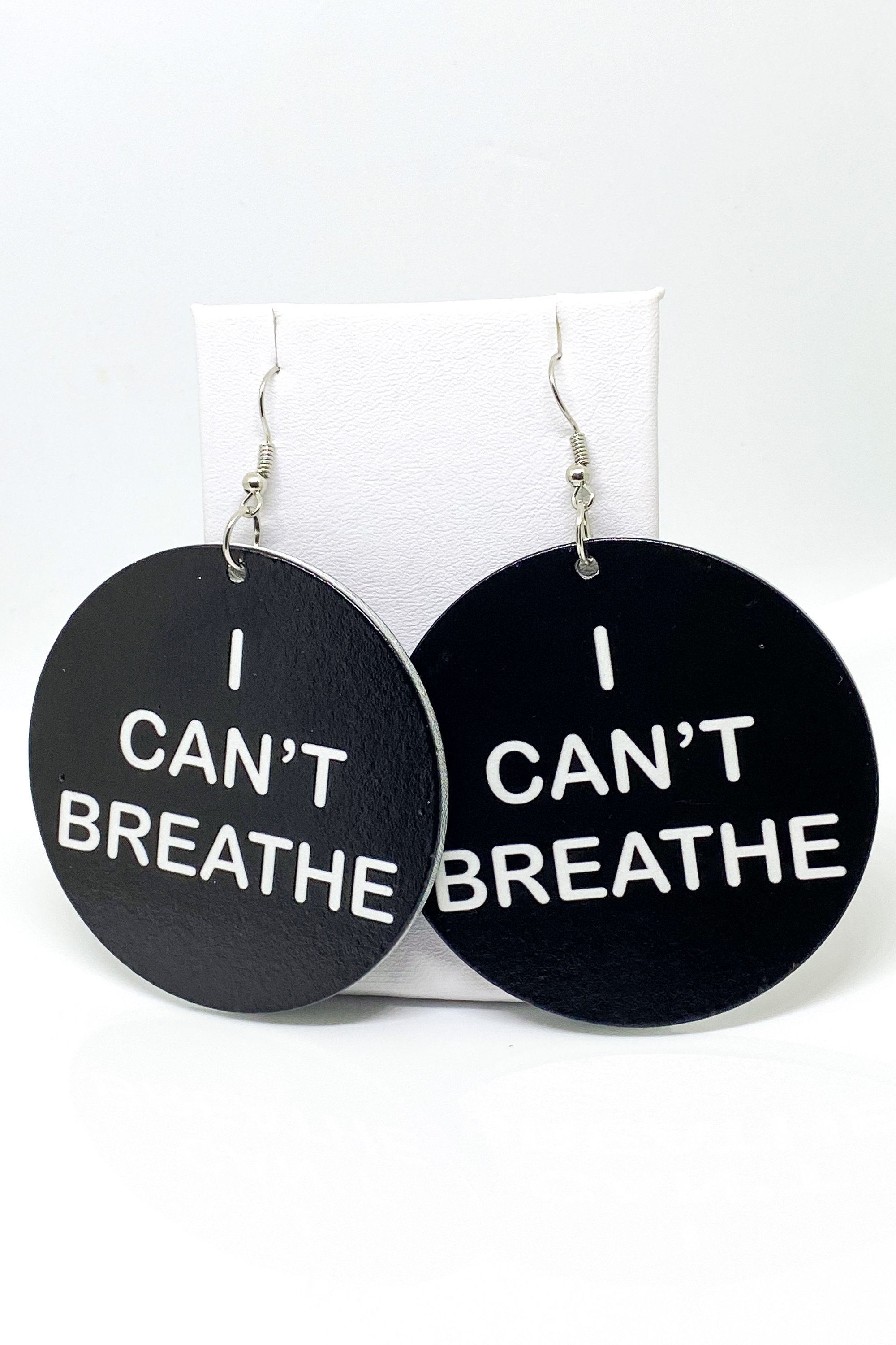 Hoops - I Can’t Breathe earrings featuring a round wooden design with a black print, showcasing their cultural and stylish appeal.