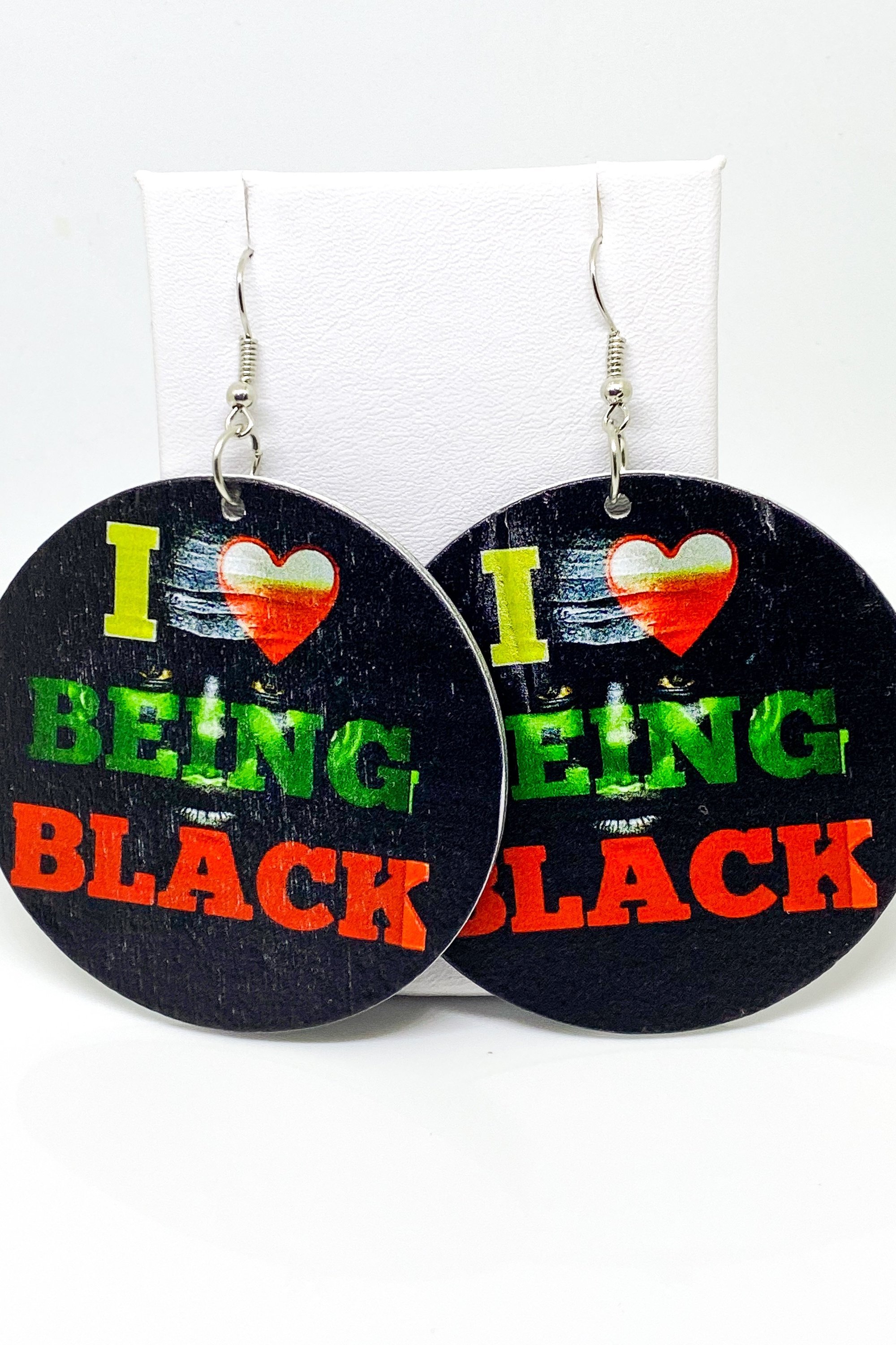 Hoops - I Love Being Black earrings featuring vibrant colors and a unique cultural design, handmade from wood with brass ear hooks.