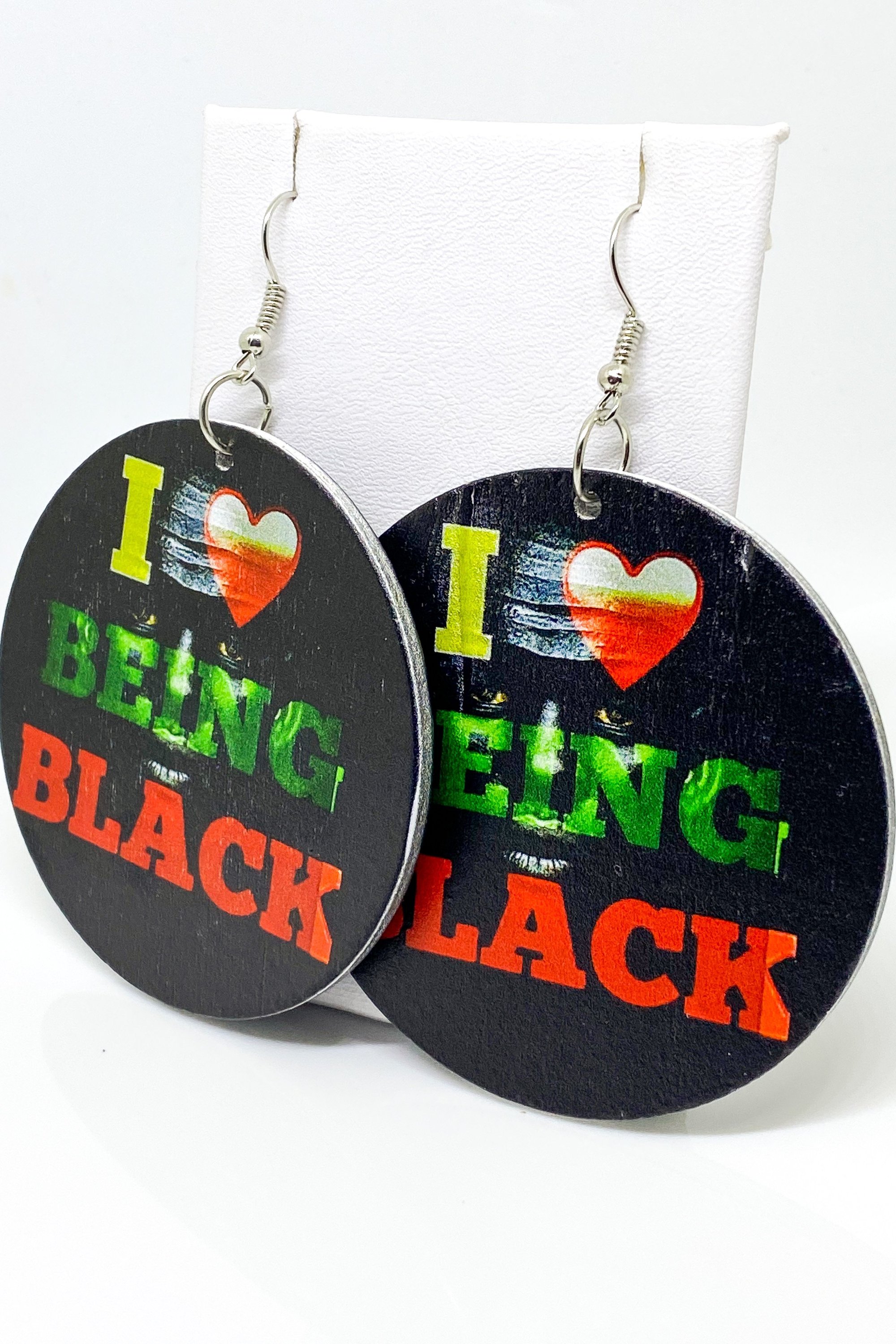 Hoops - I Love Being Black earrings featuring vibrant colors and a unique cultural design, handmade from wood with brass ear hooks.