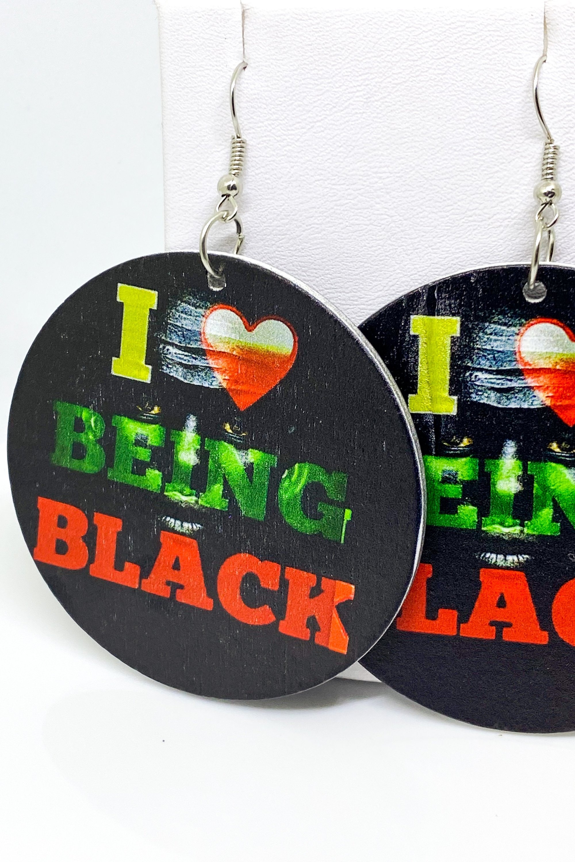 Hoops - I Love Being Black earrings featuring vibrant colors and a unique cultural design, handmade from wood with brass ear hooks.