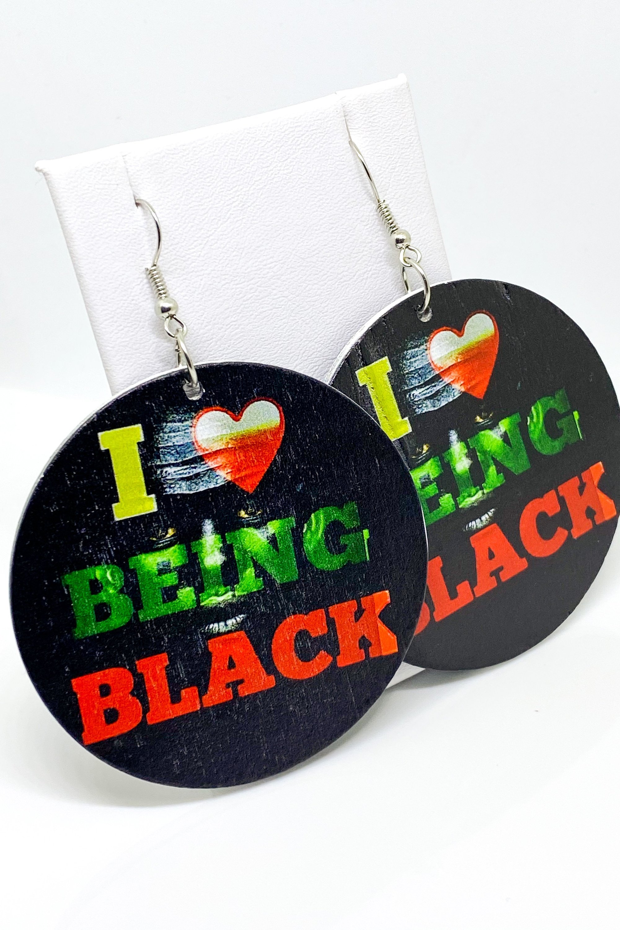 Hoops - I Love Being Black earrings featuring vibrant colors and a unique cultural design, handmade from wood with brass ear hooks.