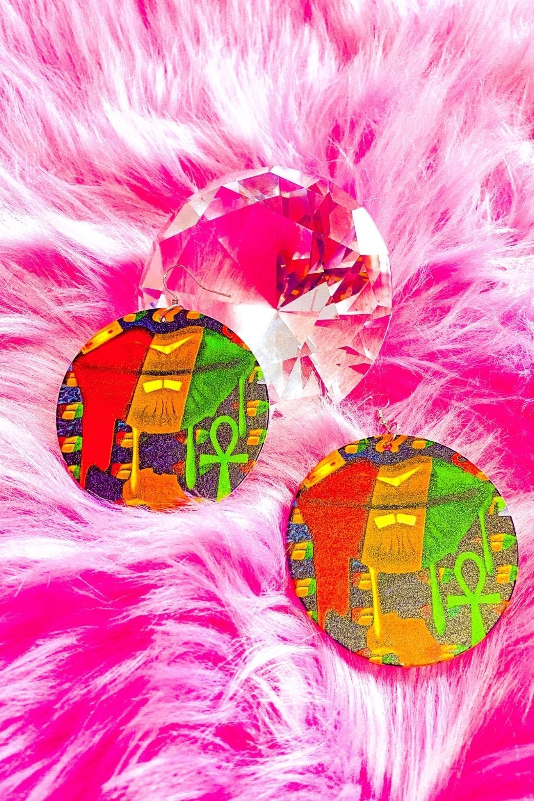 Handmade wooden hoop earrings with vibrant colors and cultural design, featuring a unique print on both sides.