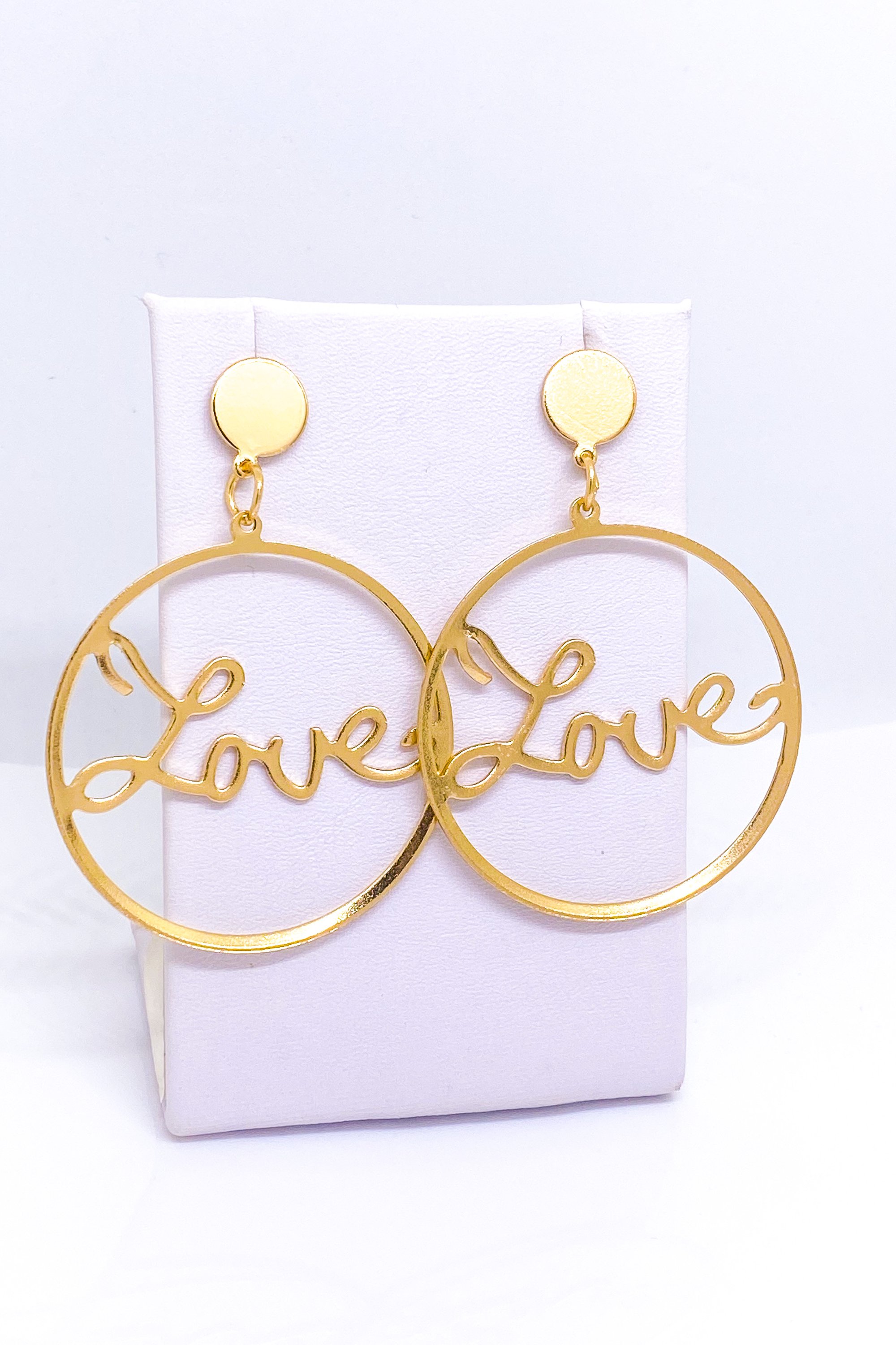 A pair of elegant dangle hoop earrings in silver and gold, showcasing a geometric round design made from high-quality zinc alloy.