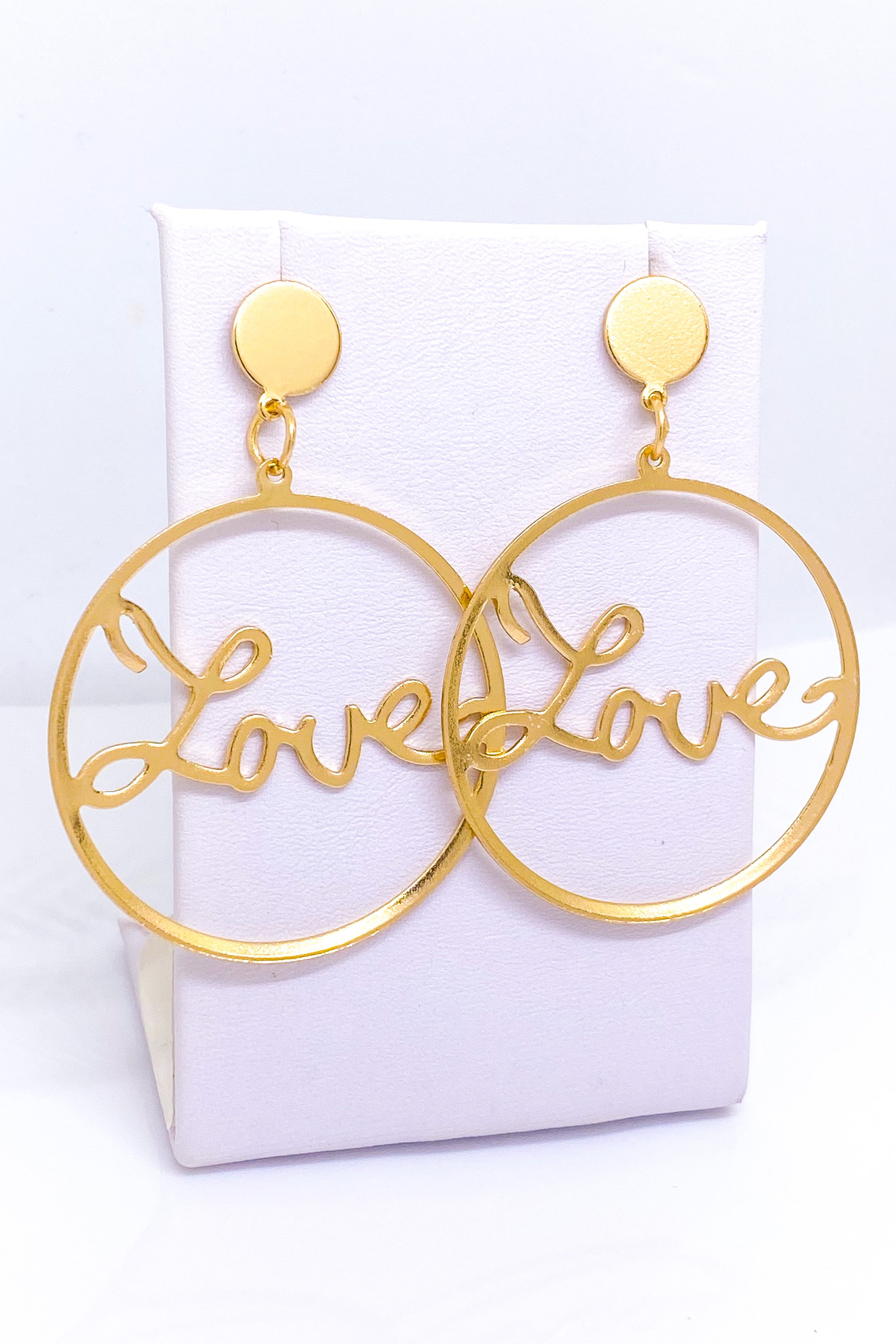 A pair of elegant dangle hoop earrings in silver and gold, showcasing a geometric round design made from high-quality zinc alloy.